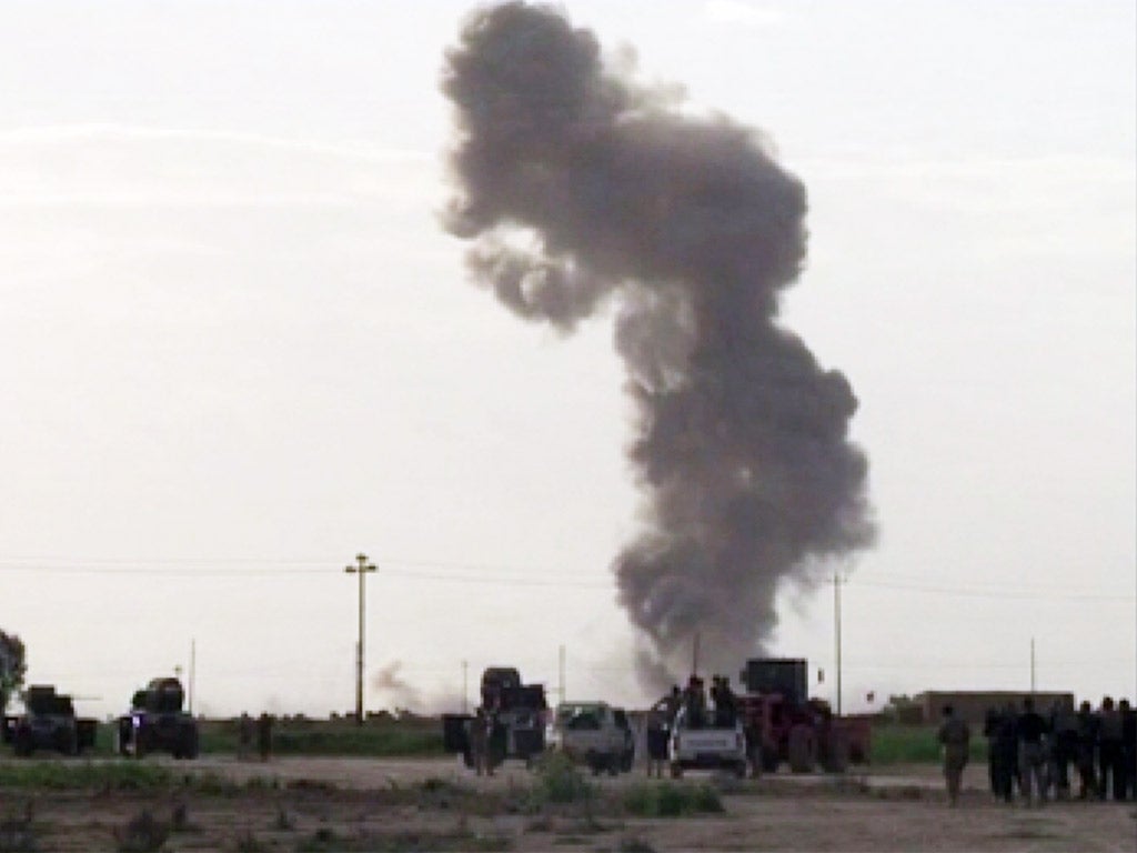 Smoke rises from an explosion as Iraqi forces, Shiite militiamen and Sunni tribal fighters battle Islamic State militants for control of Tikrit