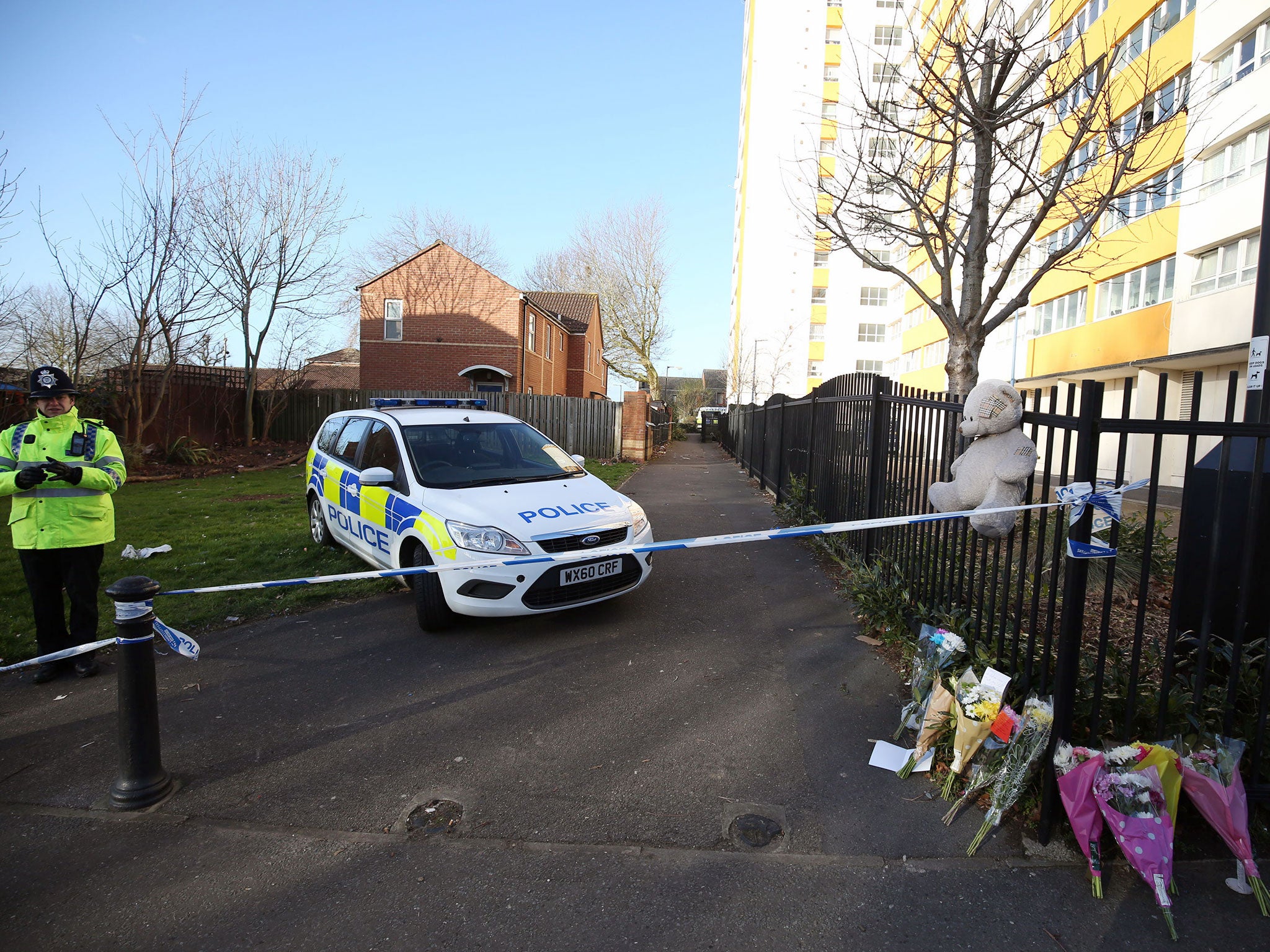 A teddy bear and floral tributes have been left near Barton Court in Bristol