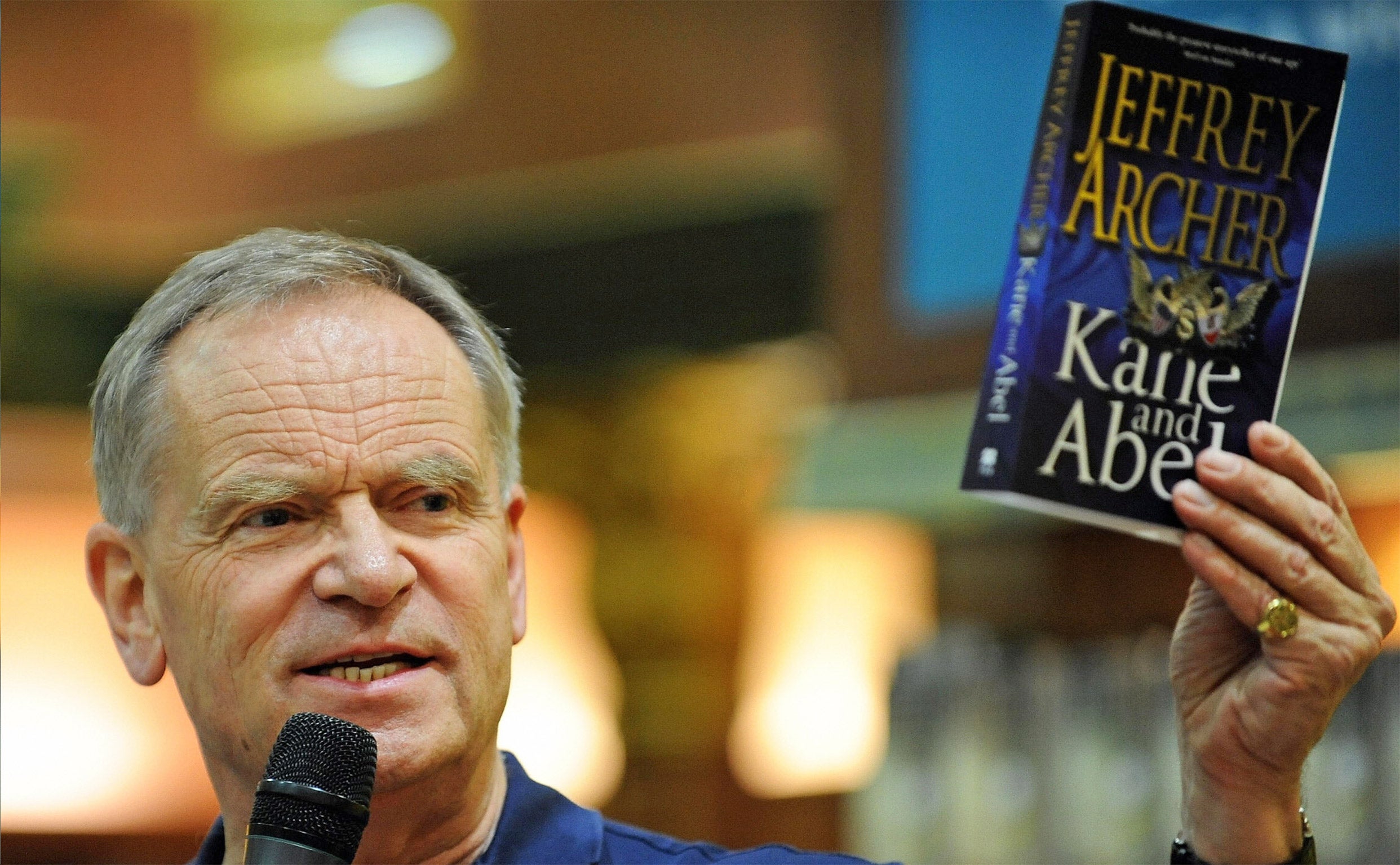 Jeffrey Archer holds up a copy of 'Kane and Abel', a book he says was ripped-off by Bollywood