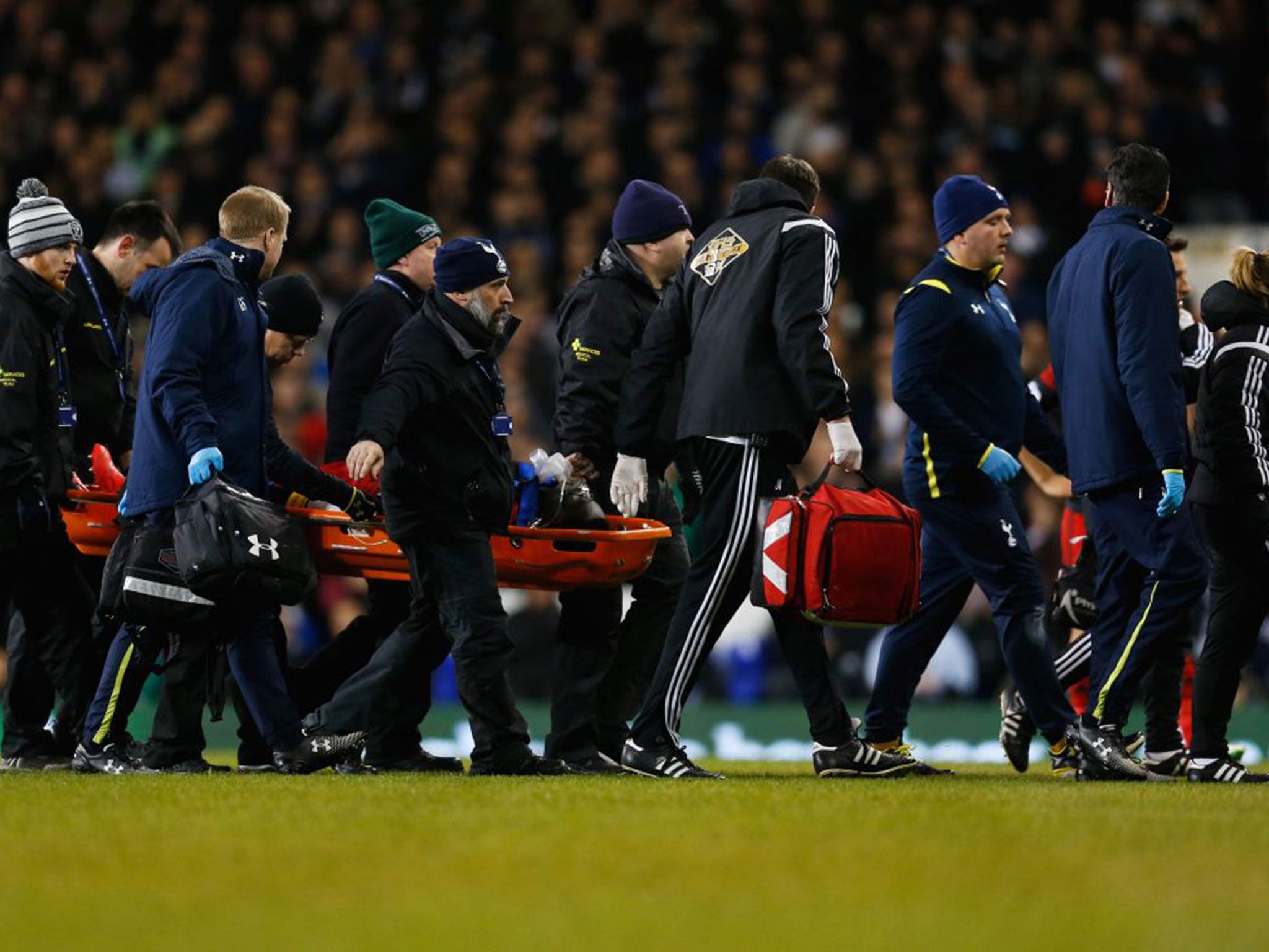 Bafetibis Gomis of Swansea City is stretchered off at White Hart Lane