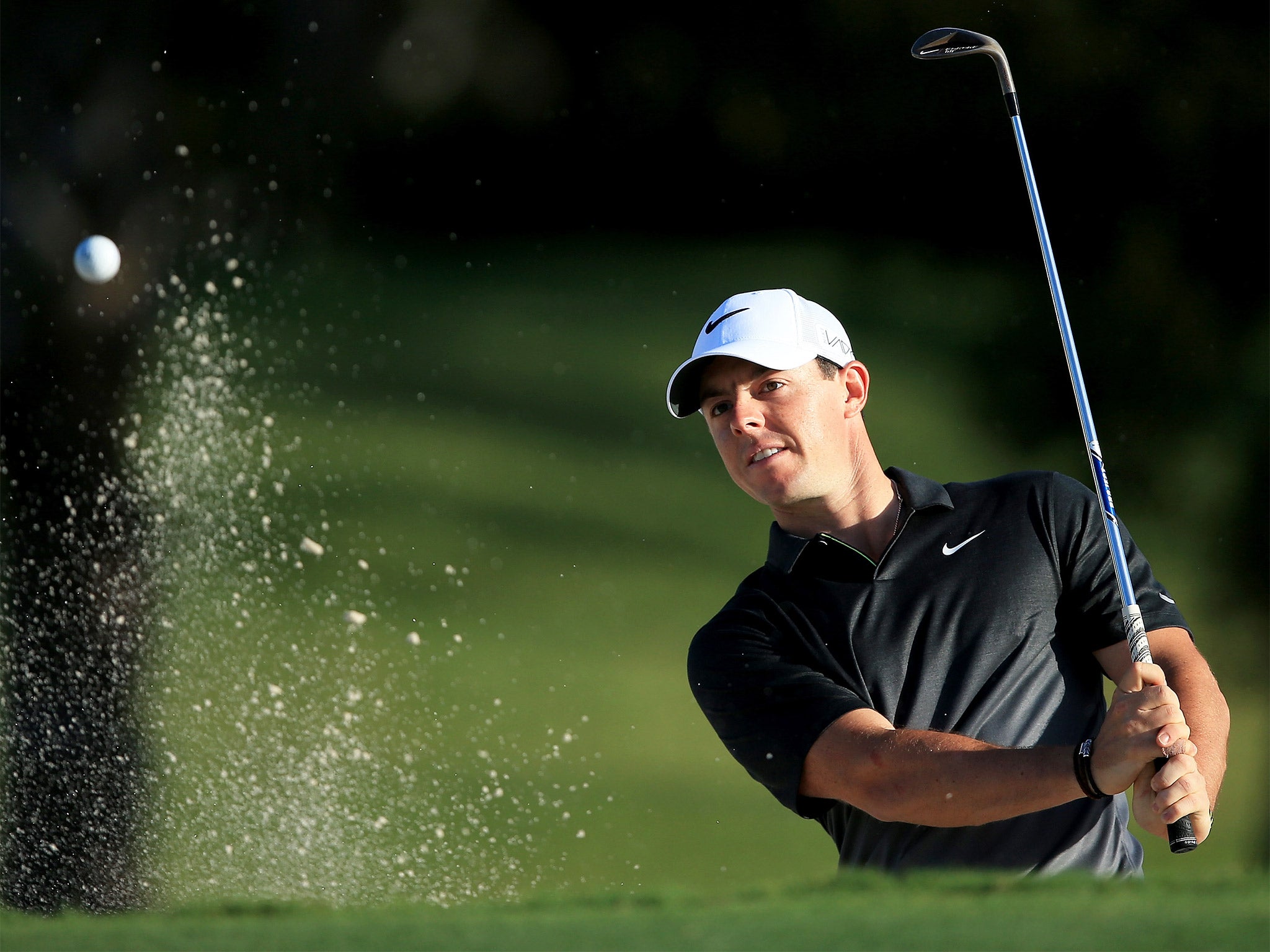 Rory McIlroy plays out of a bunker during a practice round on Wednesday