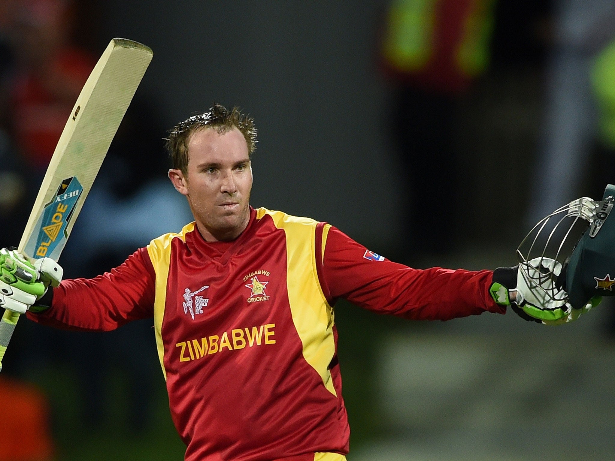 Brendan Taylor celebrates reaching his century during Zimbabwe's run chase