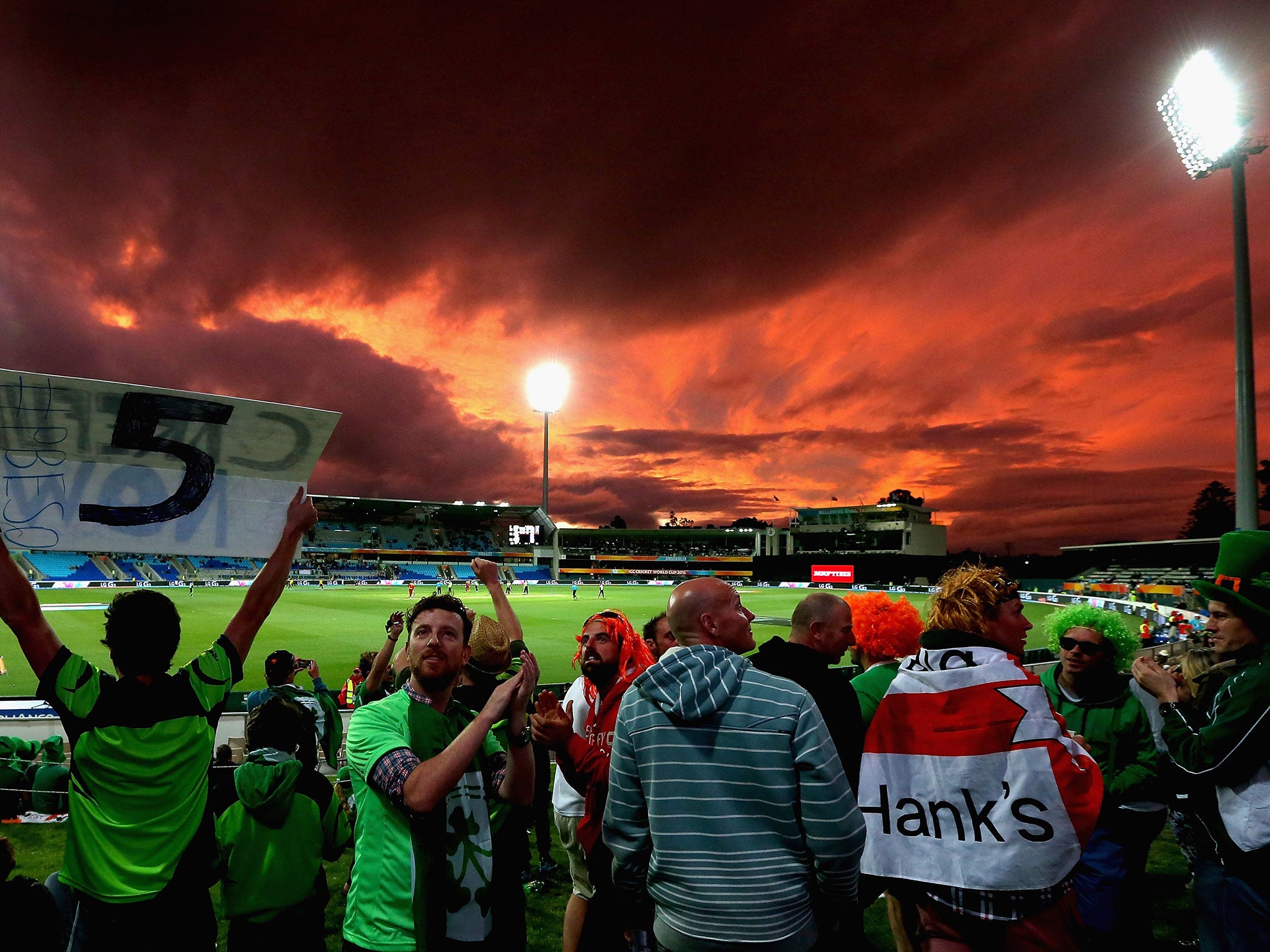 Irish fans celebrate as the sun sets over the Bellerive Oval