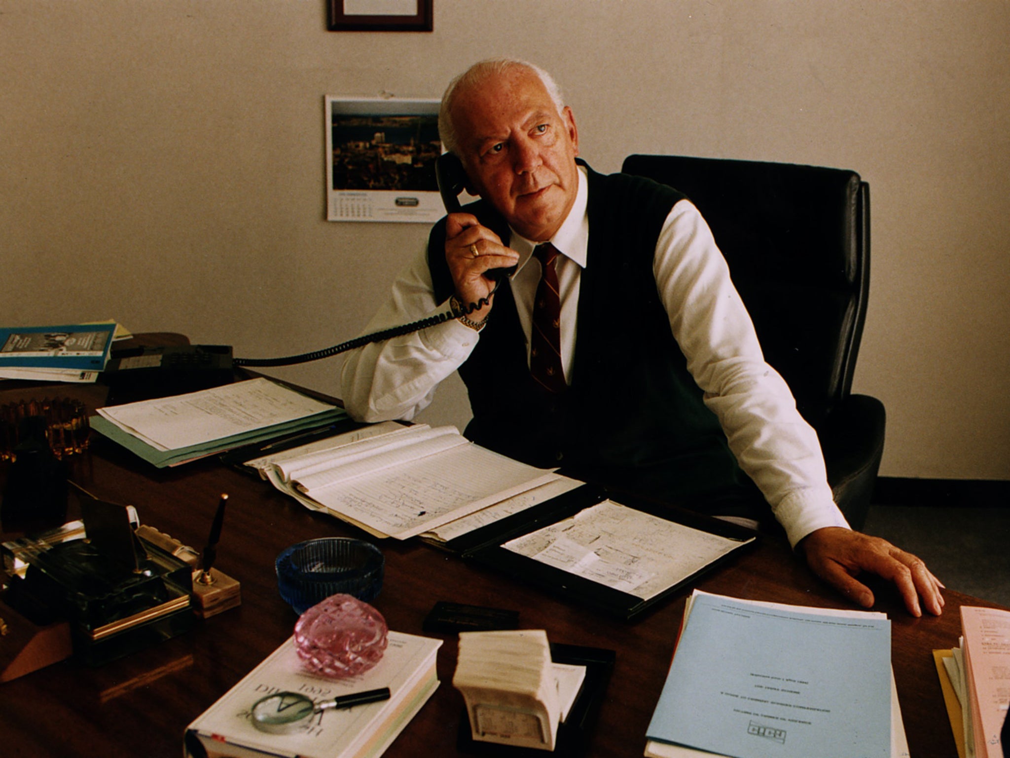 Joe Beltrami top defence lawyer on phone behind desk in Glasgow office