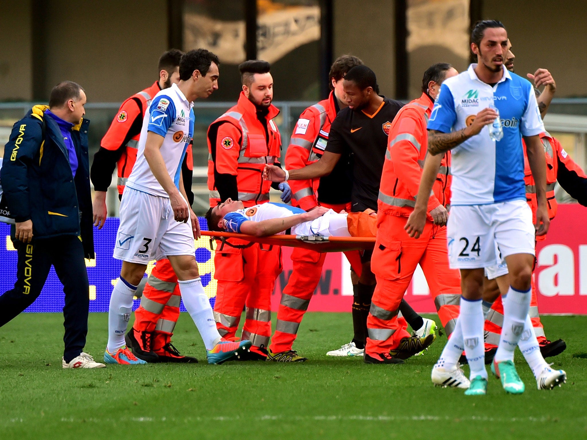 Federico Mattiello (centre) is taken off the field on a stretcher