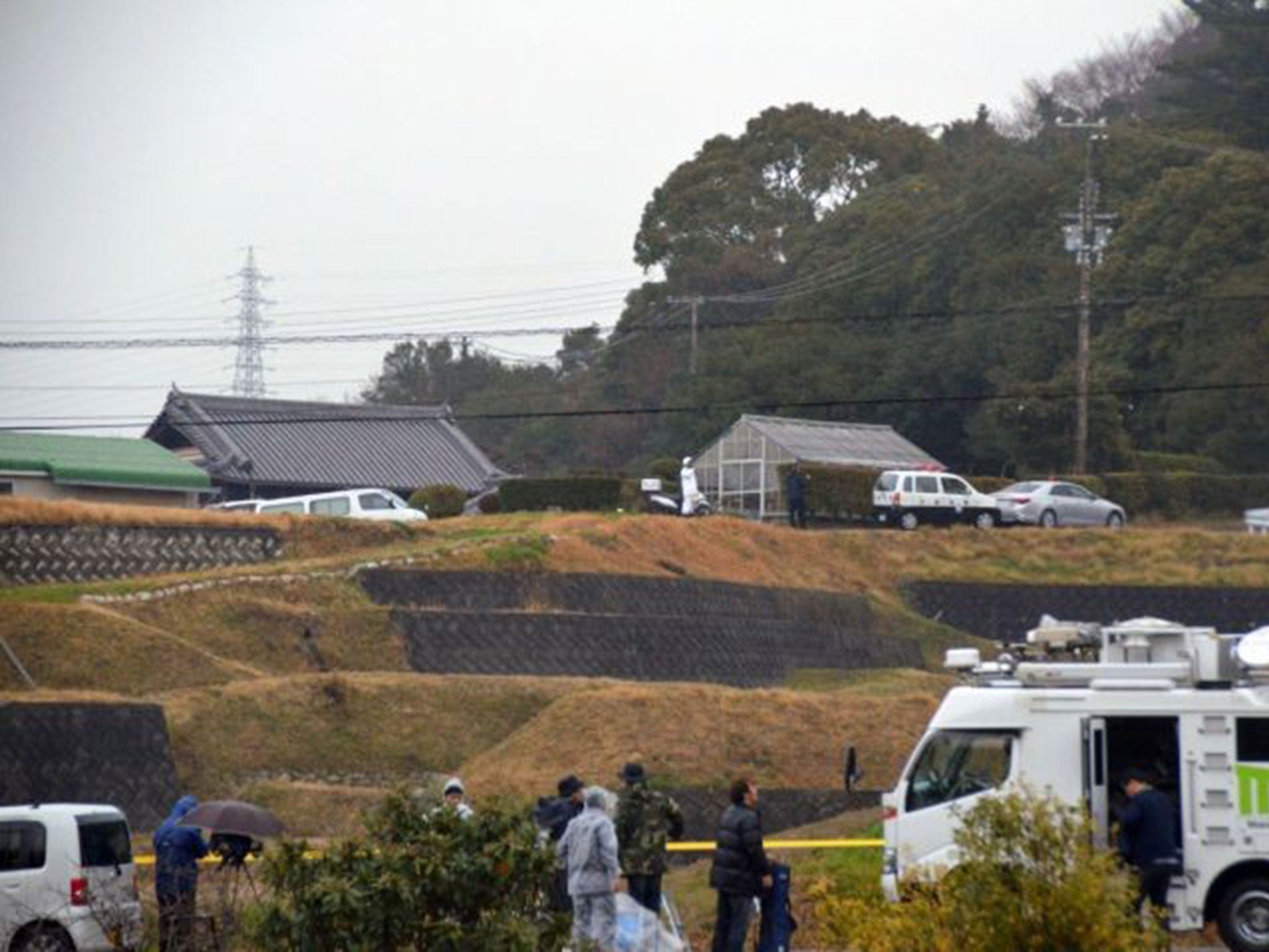 Police officers near houses where a man stabbed five people to death at Sumoto city in Awajishima island, Japan on March 9, 2015.