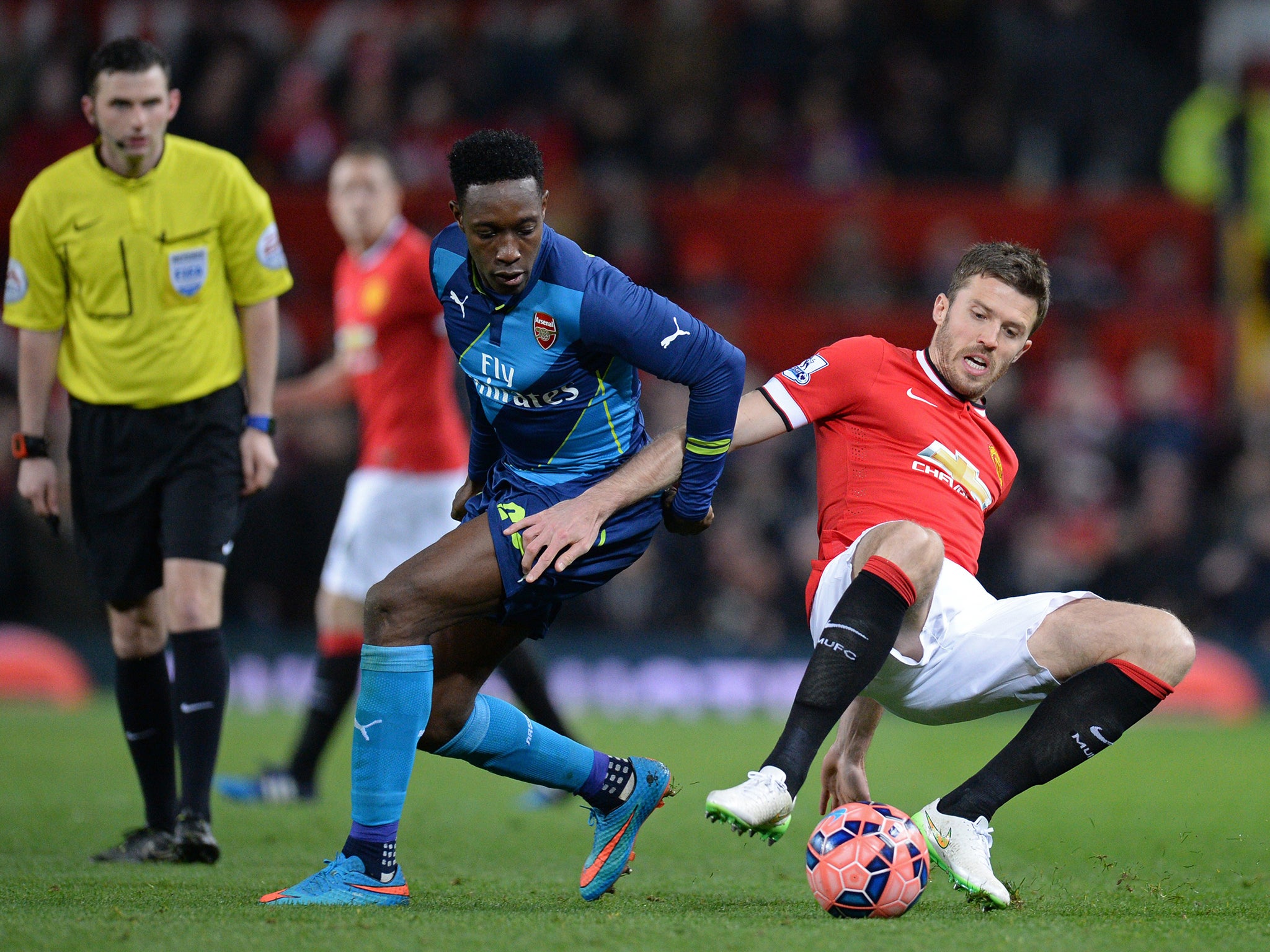 Michael Carrick and Danny Welbeck challenge for the ball