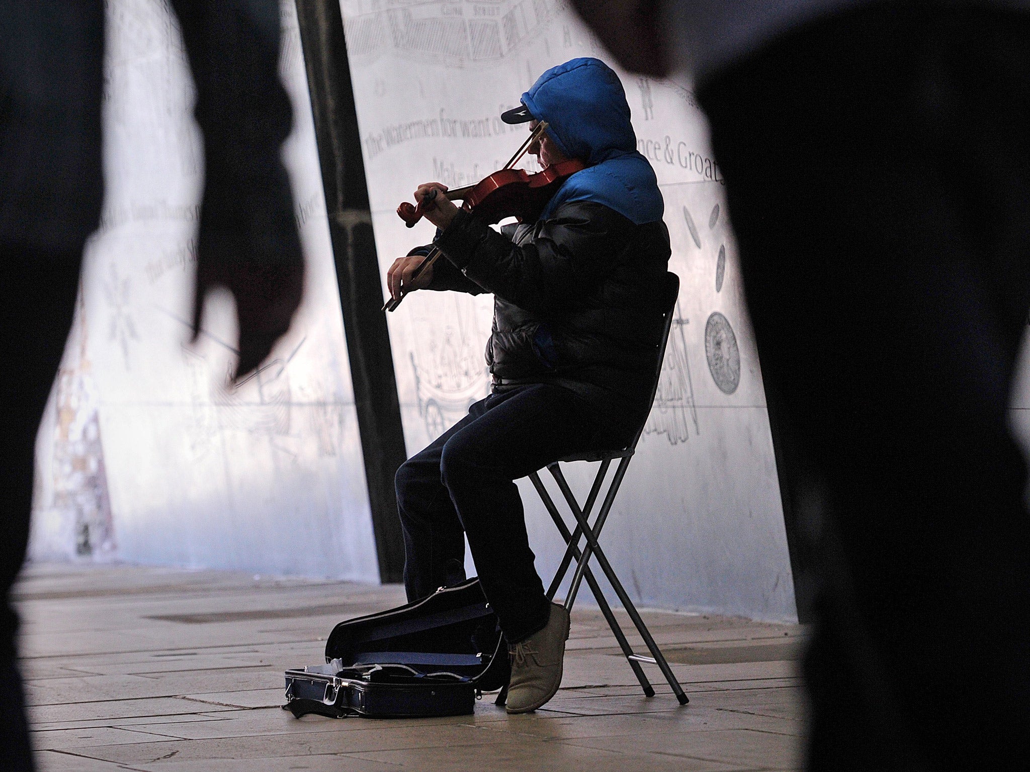 A busker plays the violin on the Southbank in central London