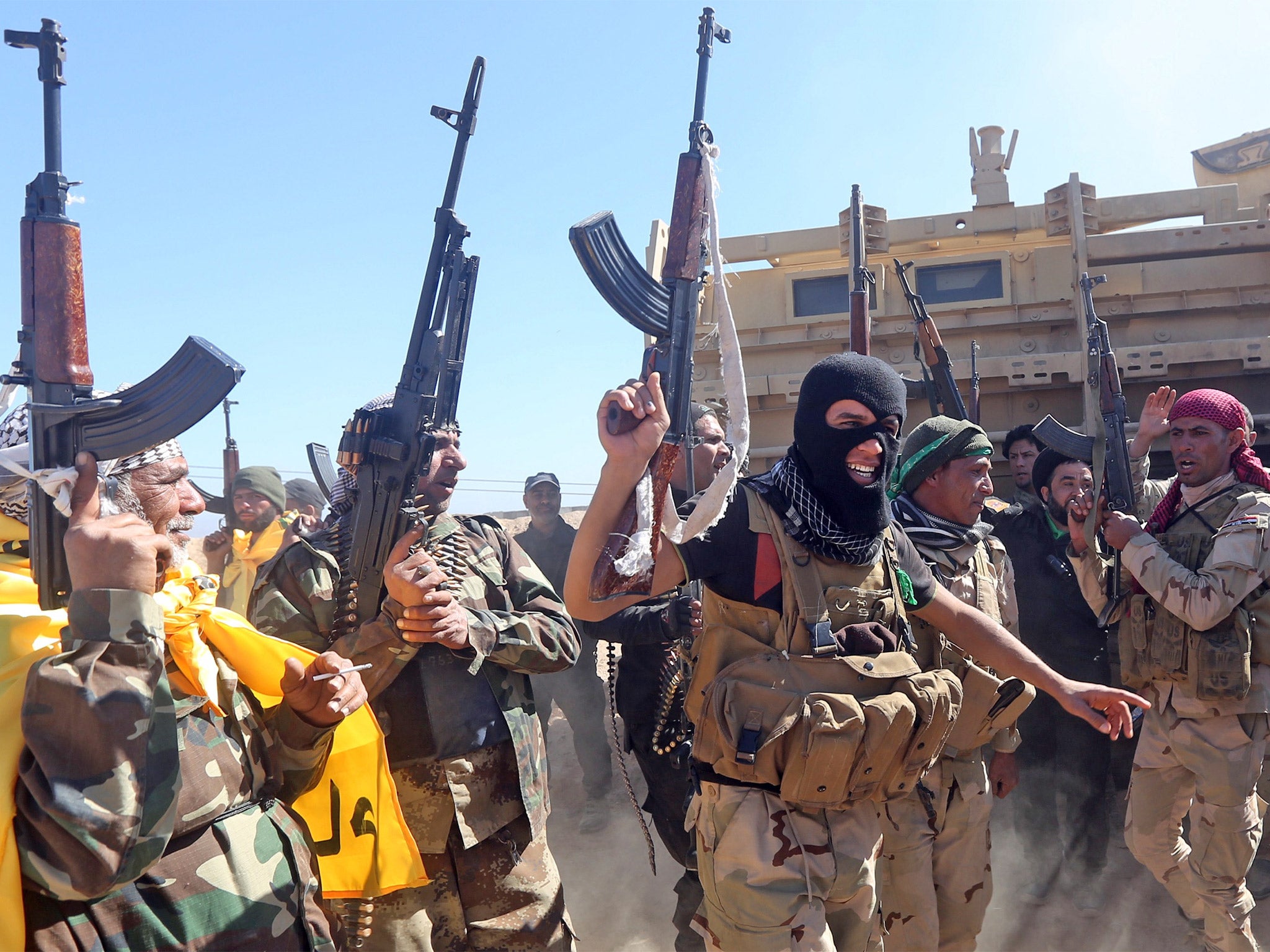 Iraqi pro-government fighters celebrate as they advance into Tikrit