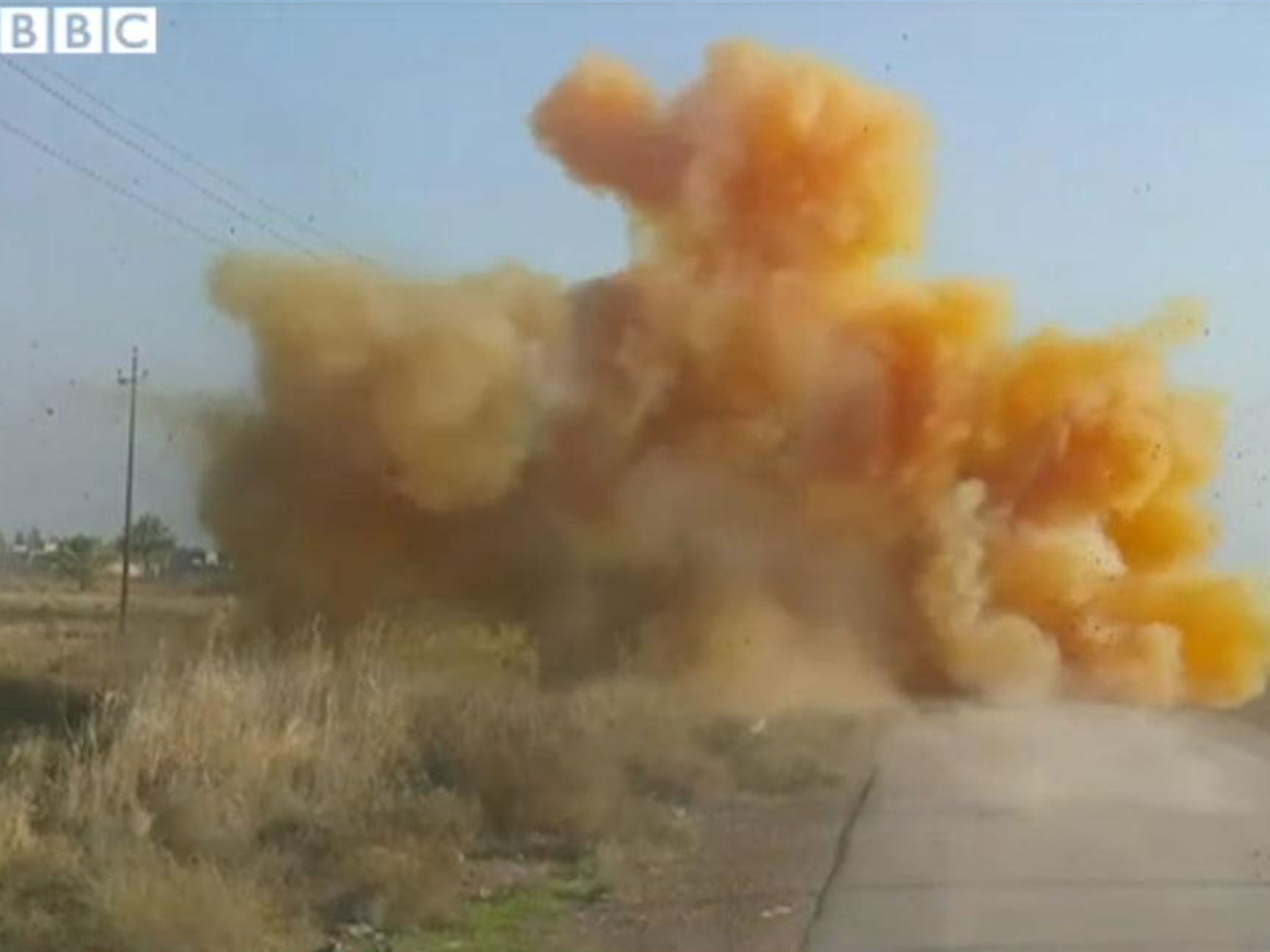 What is believed to be chlorine gas fills the air after a roadside bomb is detonated