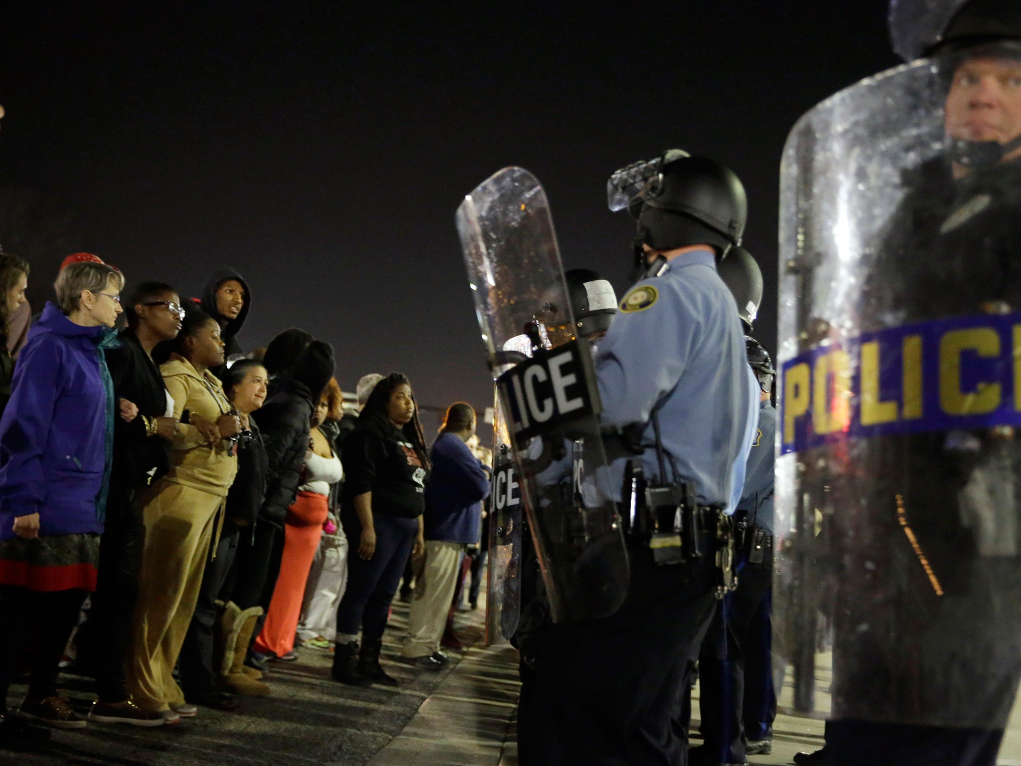 The shootings promised to inflame tensions that erupted after the killing of an unarmed black man, 18-year-old Michael Brown, by a police officer last August