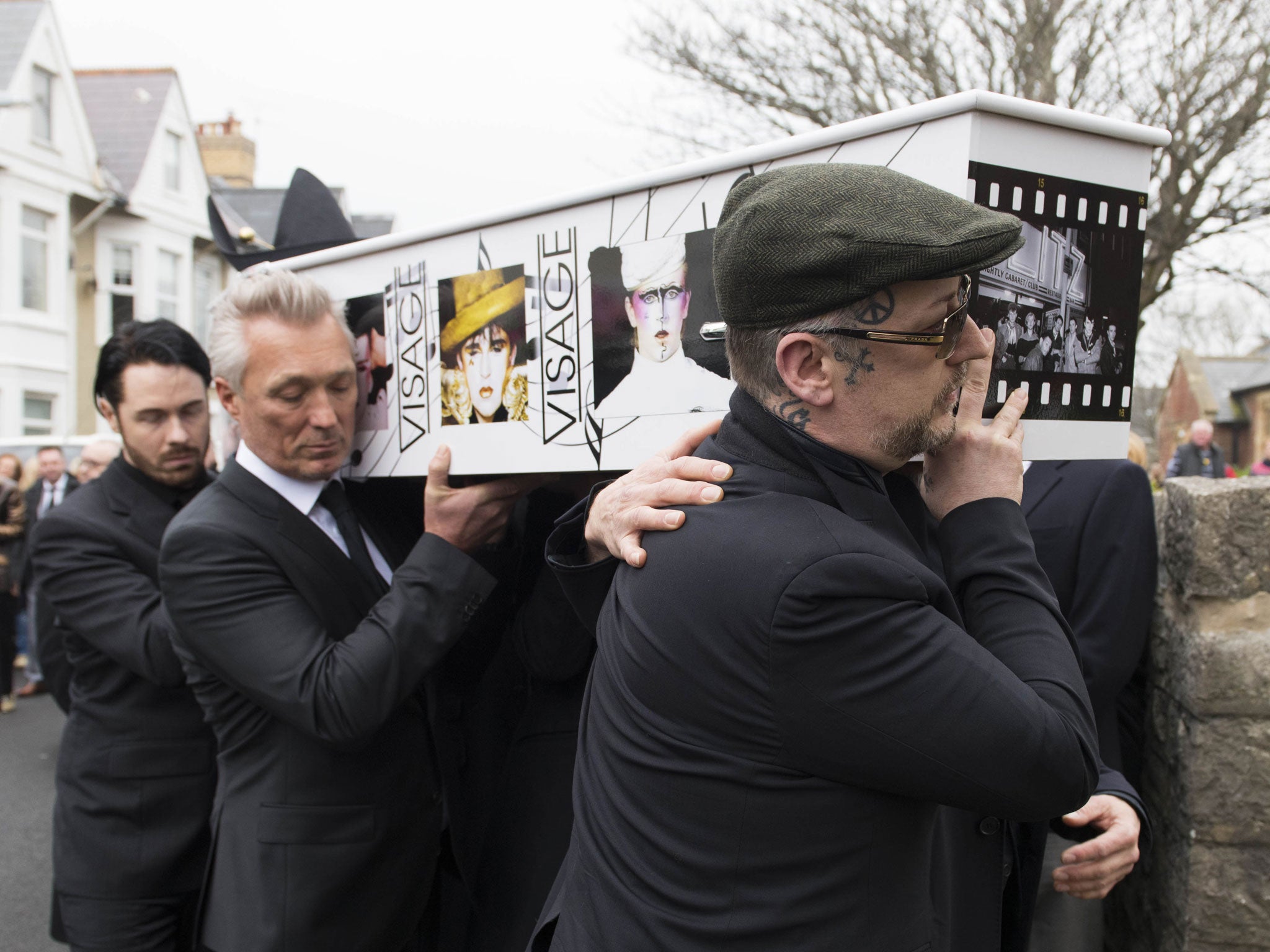 Martin Kemp (centre) and Boy George (right) carry Strange's coffin