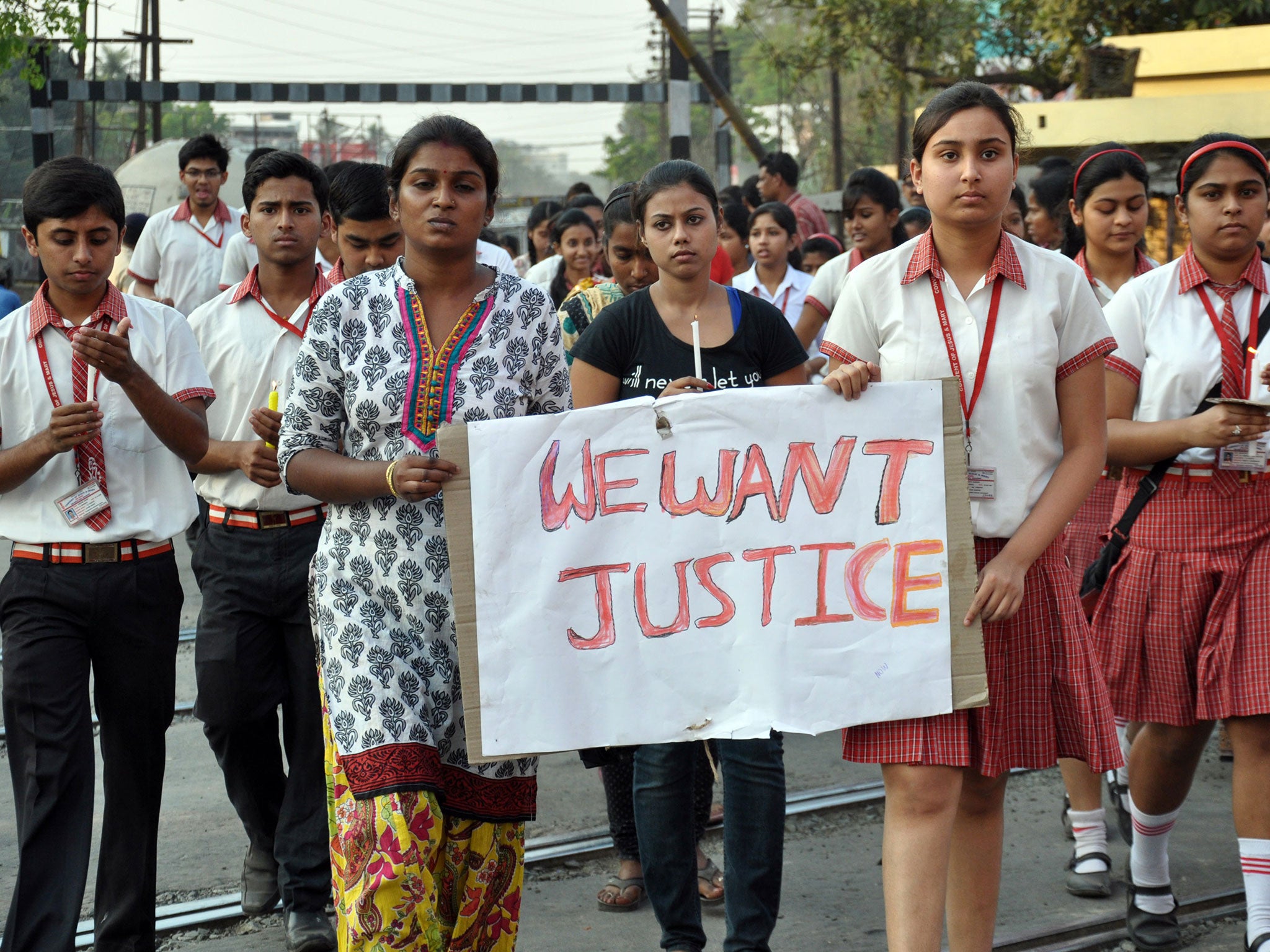 Students of the attacked convent participate in a protest against the alleged gang rape of a nun in her 70s