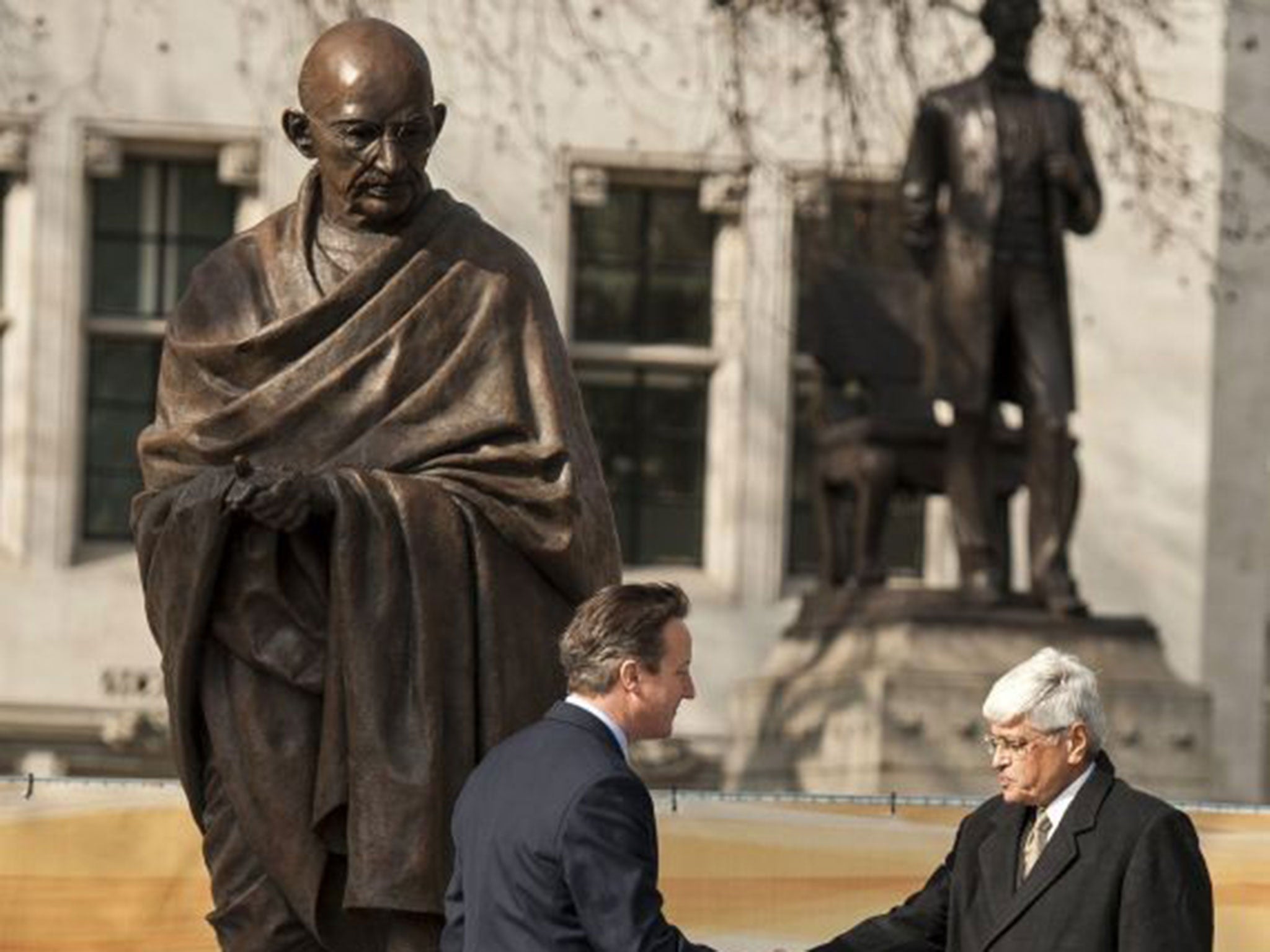 New statue of Gandhi unveiled in Parliament Square. Prime Minister David Cameron shakes hands with Mahatma Gandhi's grandson, Shri Gopalkrishna Gandhi