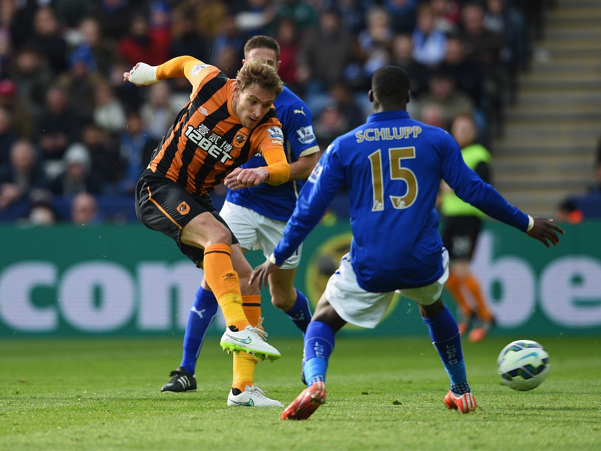 Nikica Jelevic of Hull City shoots past Jeffrey Schlupp