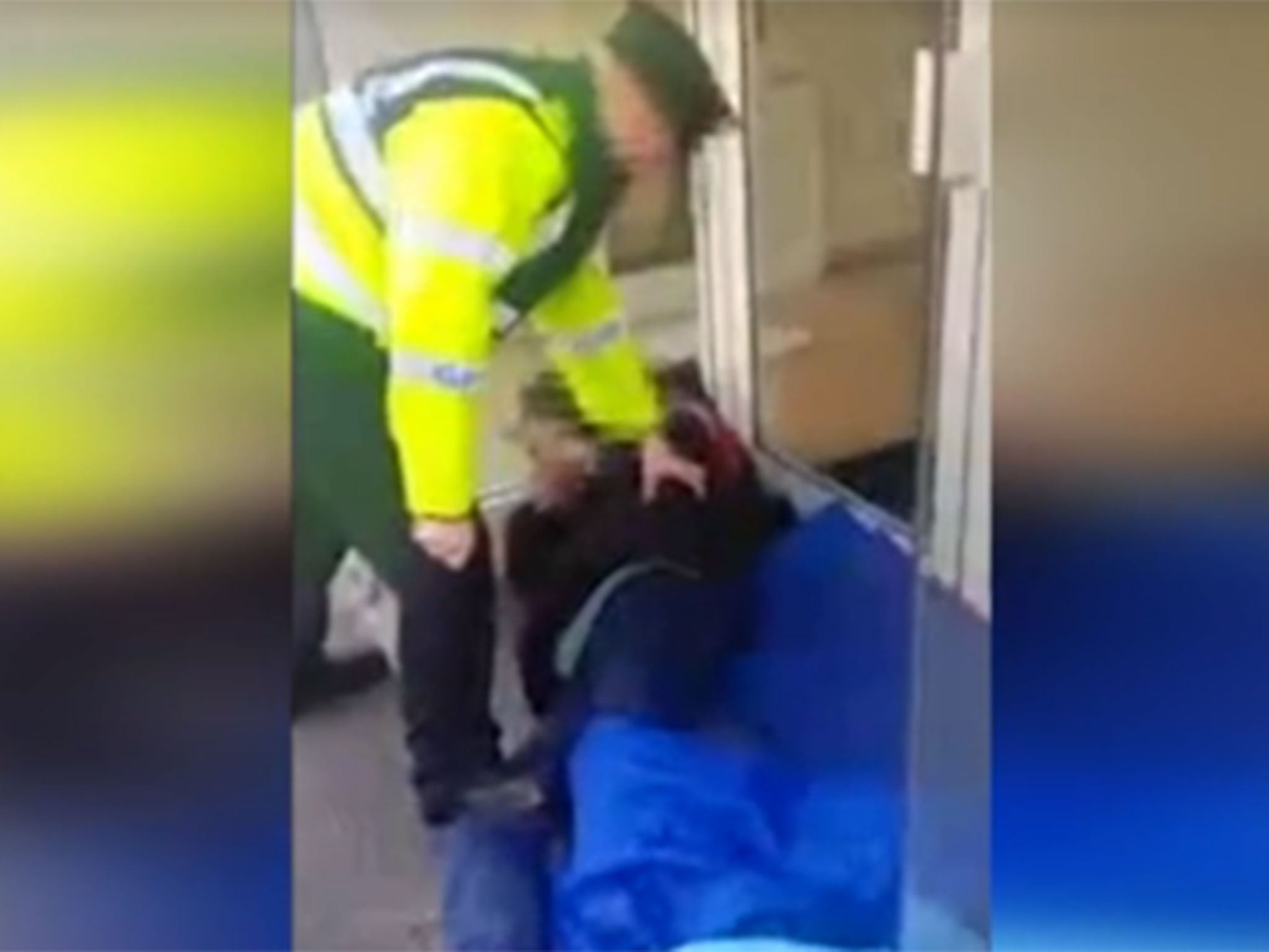 Officer appears to stand on the handcuffed homeless man