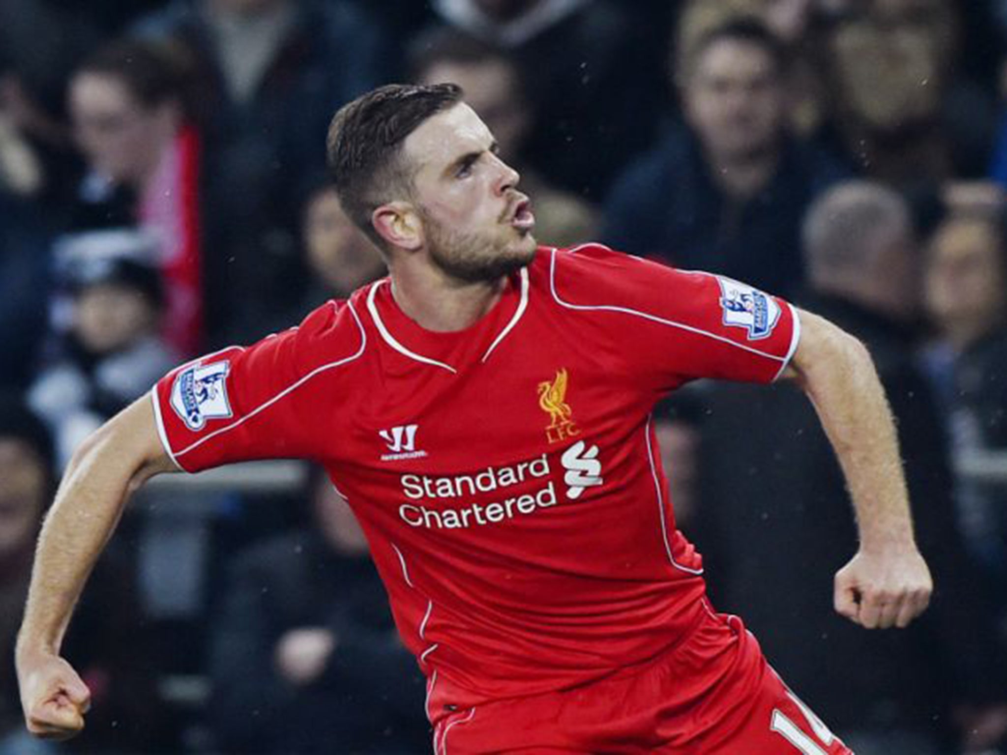 Jordan Henderson celebrates scoring Liverpool’s deflected winner in the 1-0 victory at Swansea City on Monday night