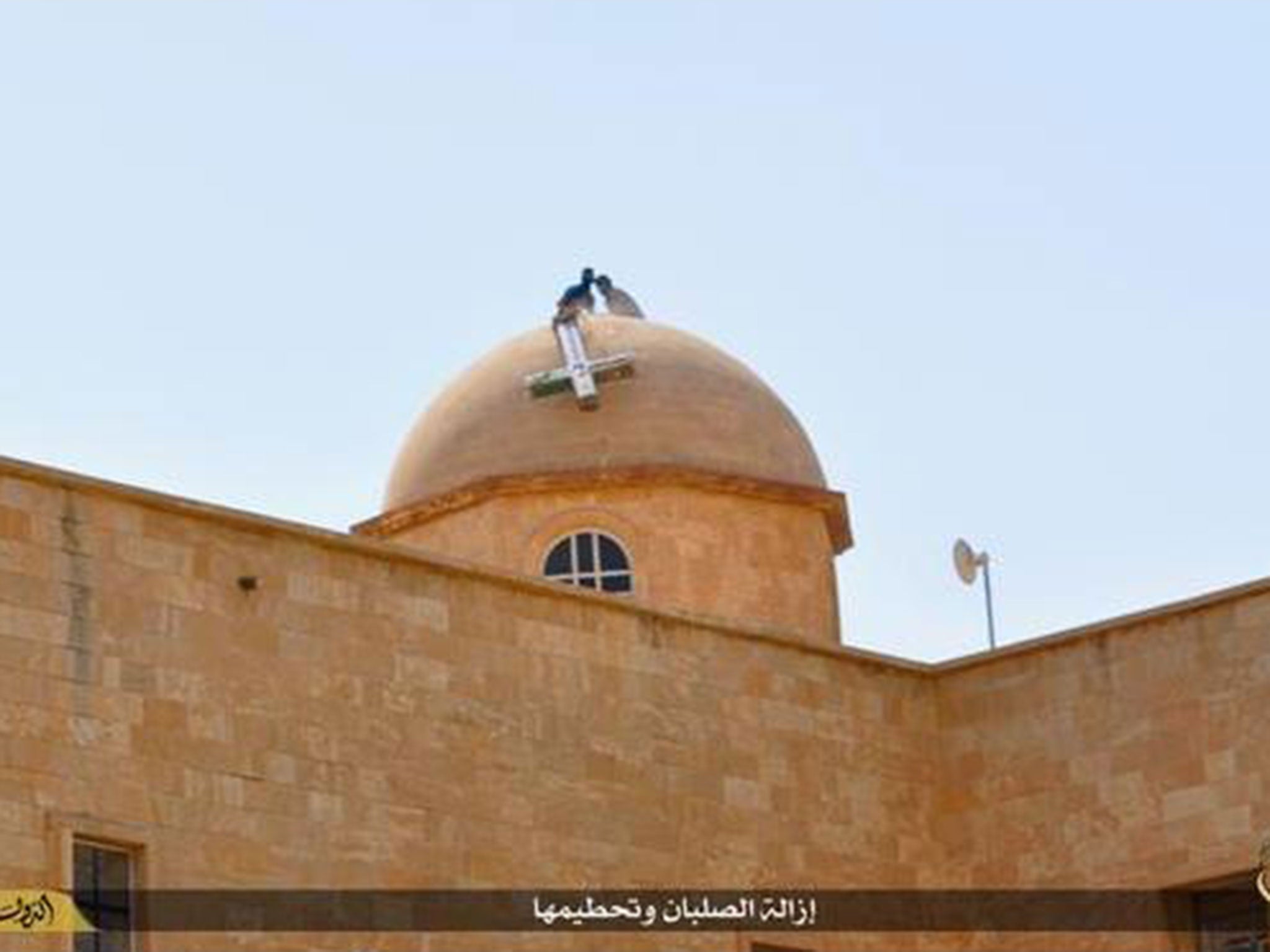 A Christian cross is removed by militants