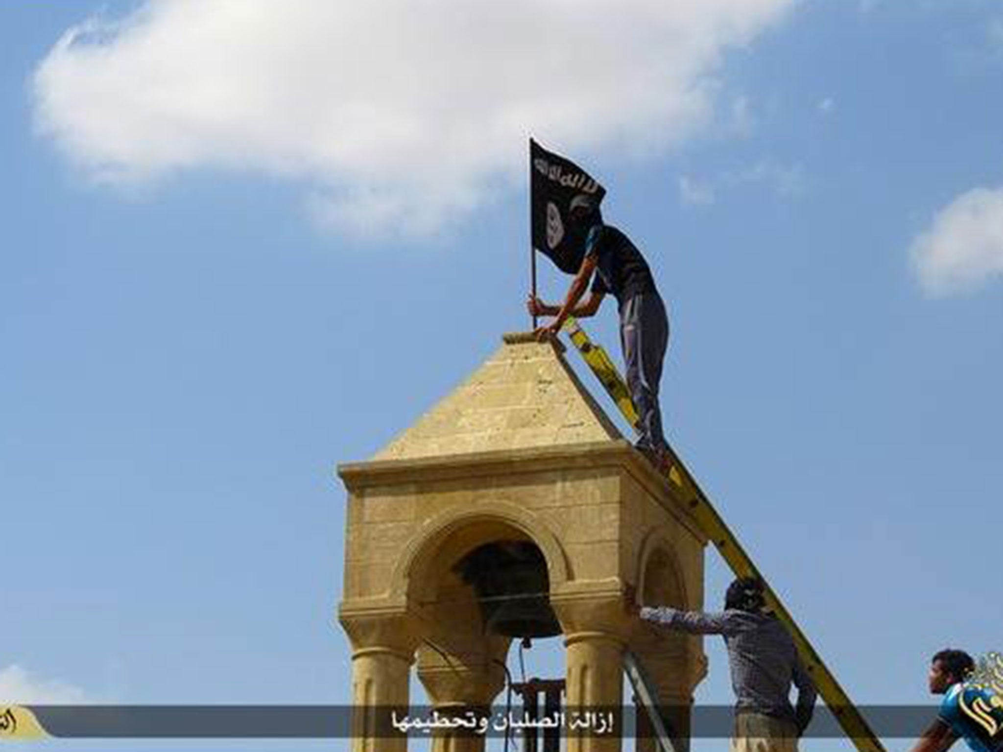 An Isis flag is placed on top of a structure