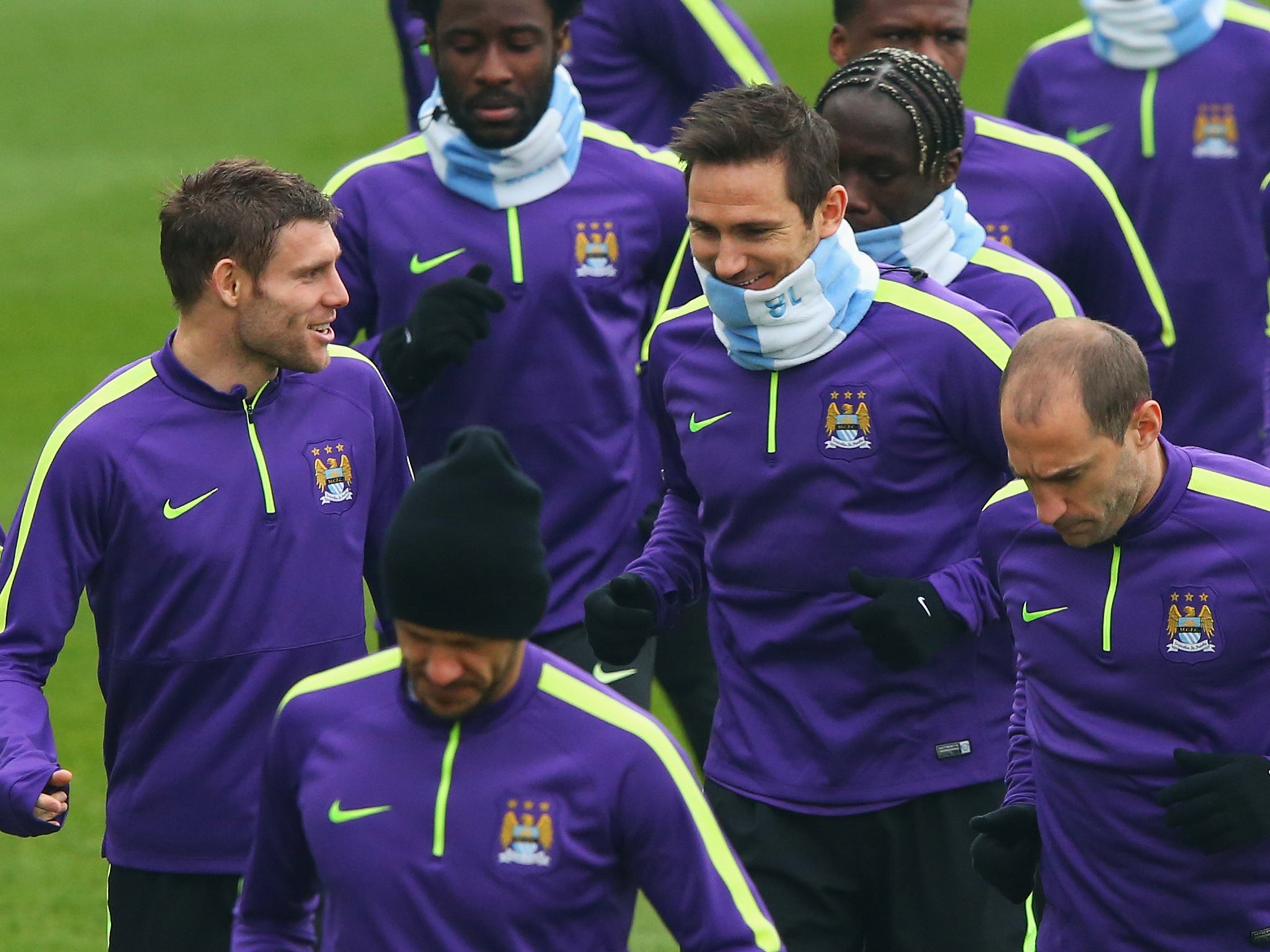 James Milner and Frank Lampard in discussion as they jog with team mates during a Manchester City training session