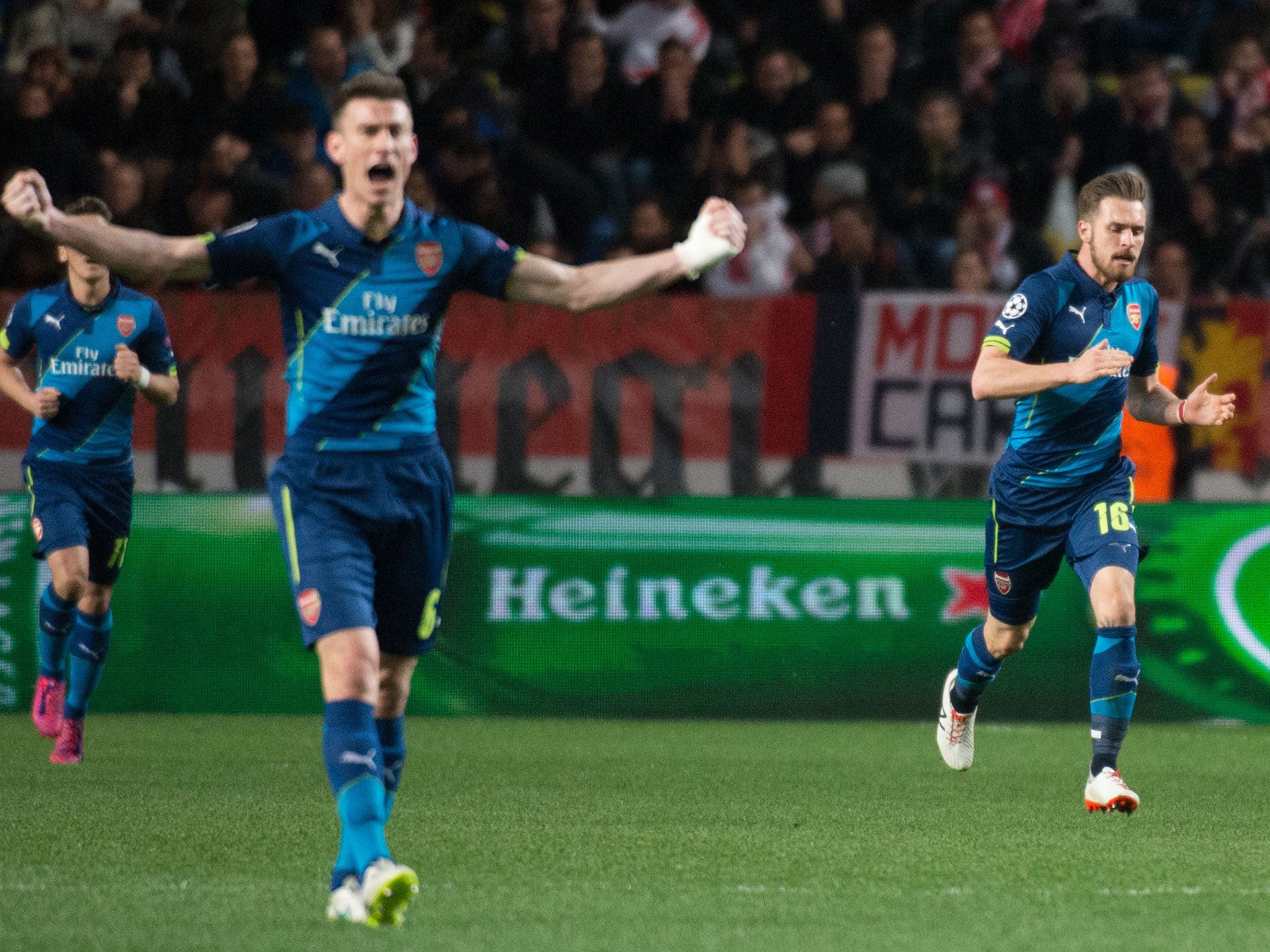 Laurent Koscielny (centre) celebrates Aaron Ramsey's (right) second for Arsenal - it wasn't enough to progress