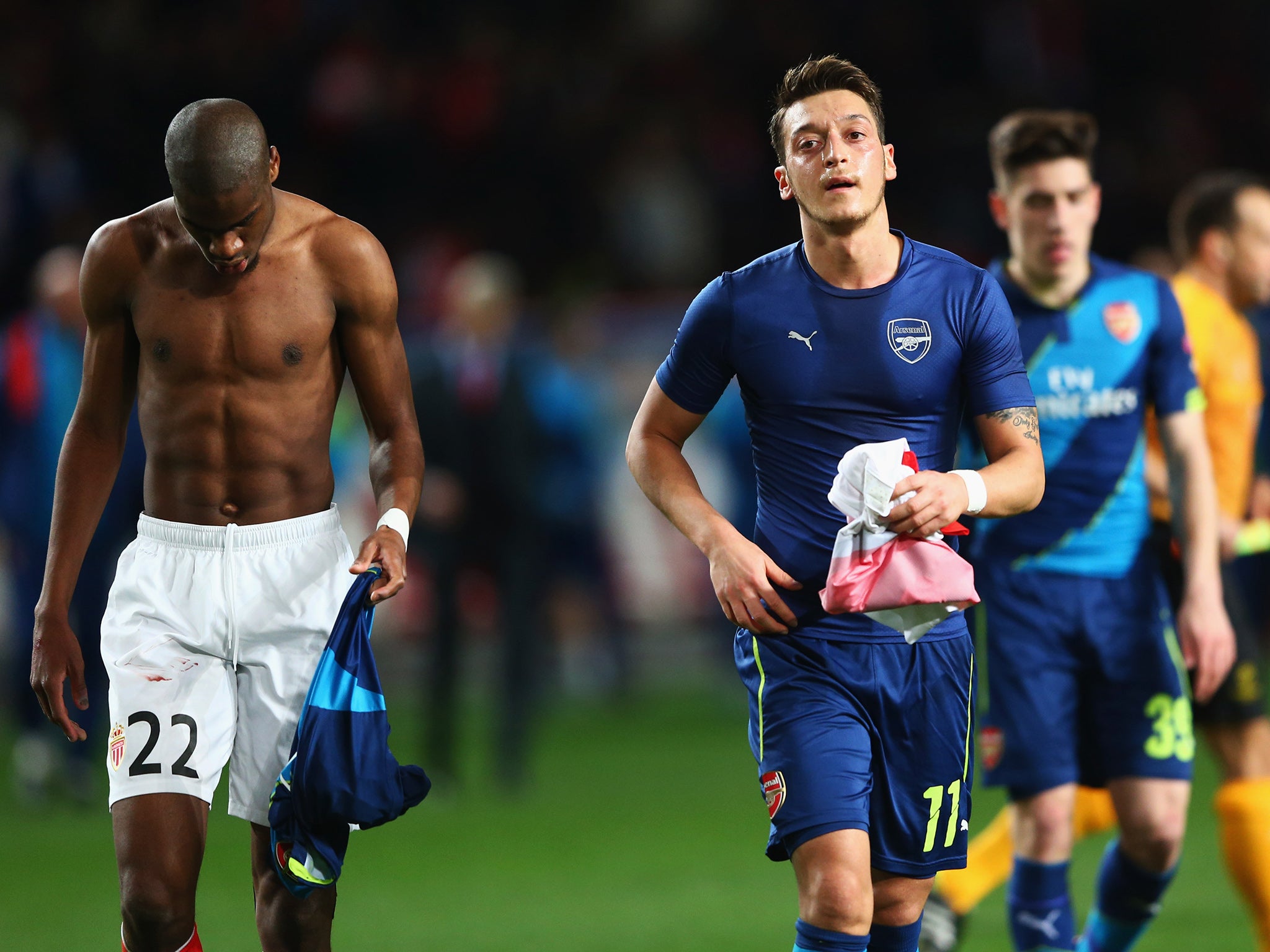 Mesut Ozil swapping shirts with Geoffrey Kondogbia at half-time