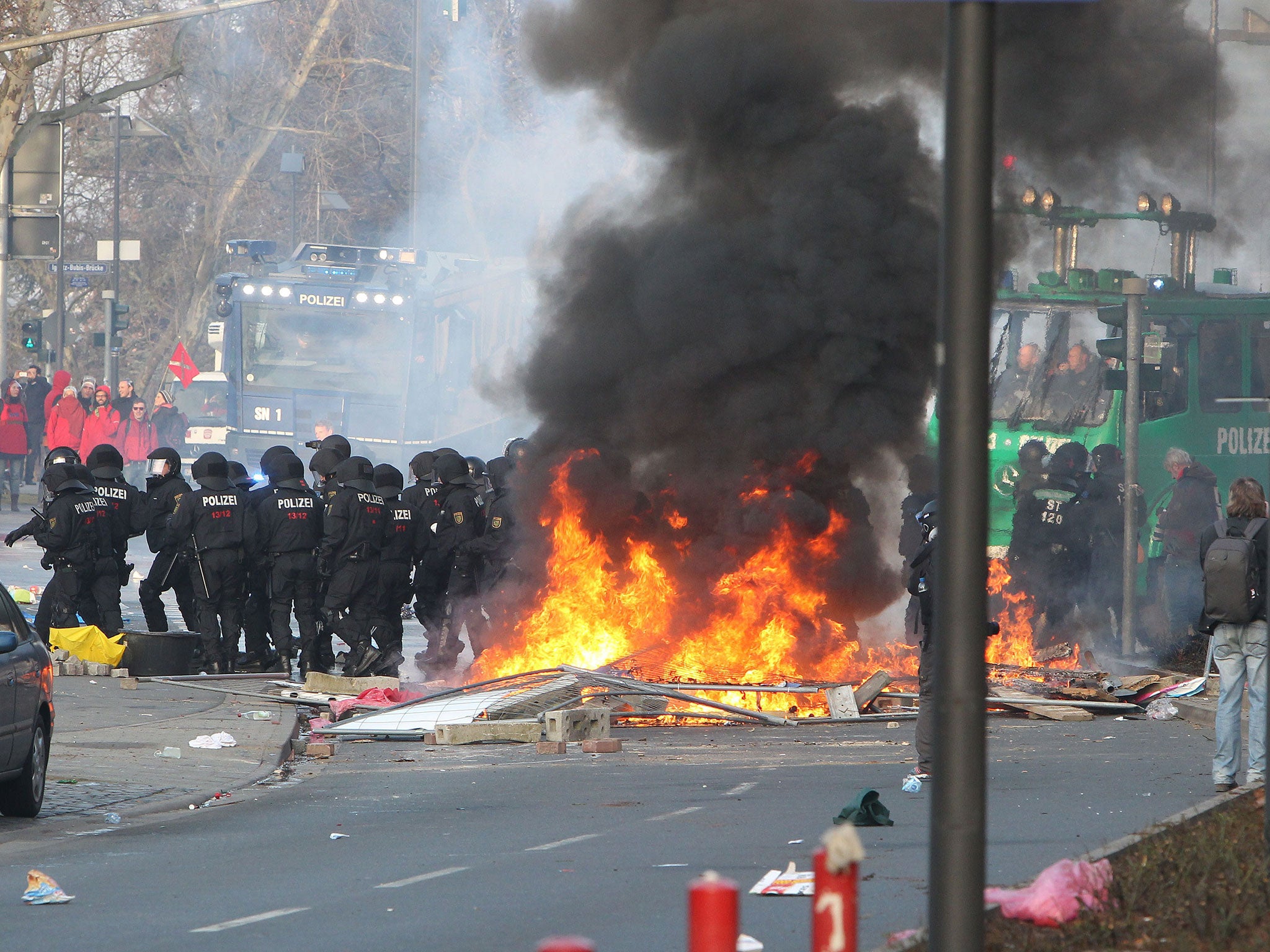 Riot police use a water cannon during clashes with protesters on the opening day of the European Central Bank (ECB) in Frankfurt, Germany, on 18 March, 2015