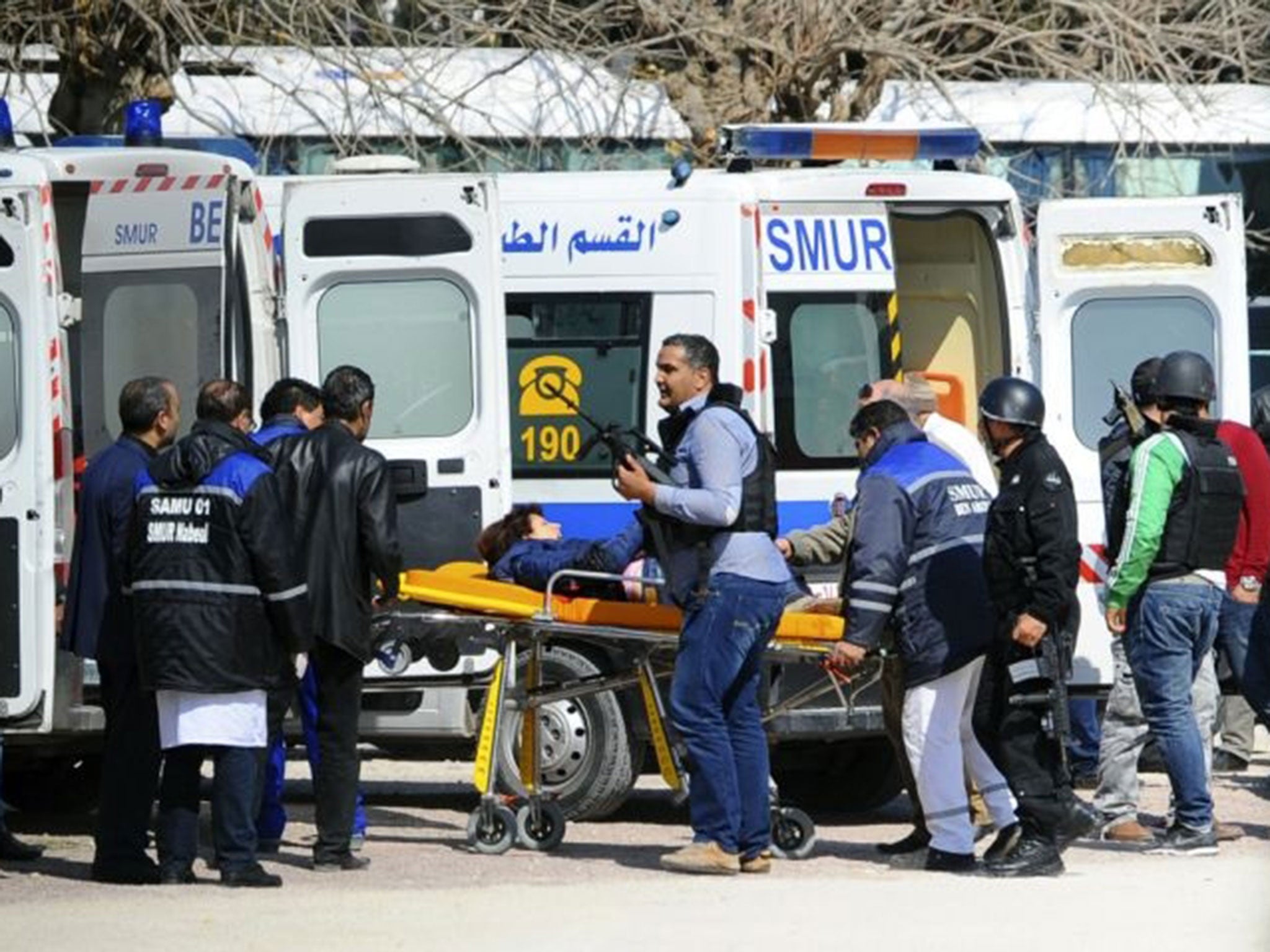 A victim is being evacuated by rescue workers outside the Bardo musum in Tunis