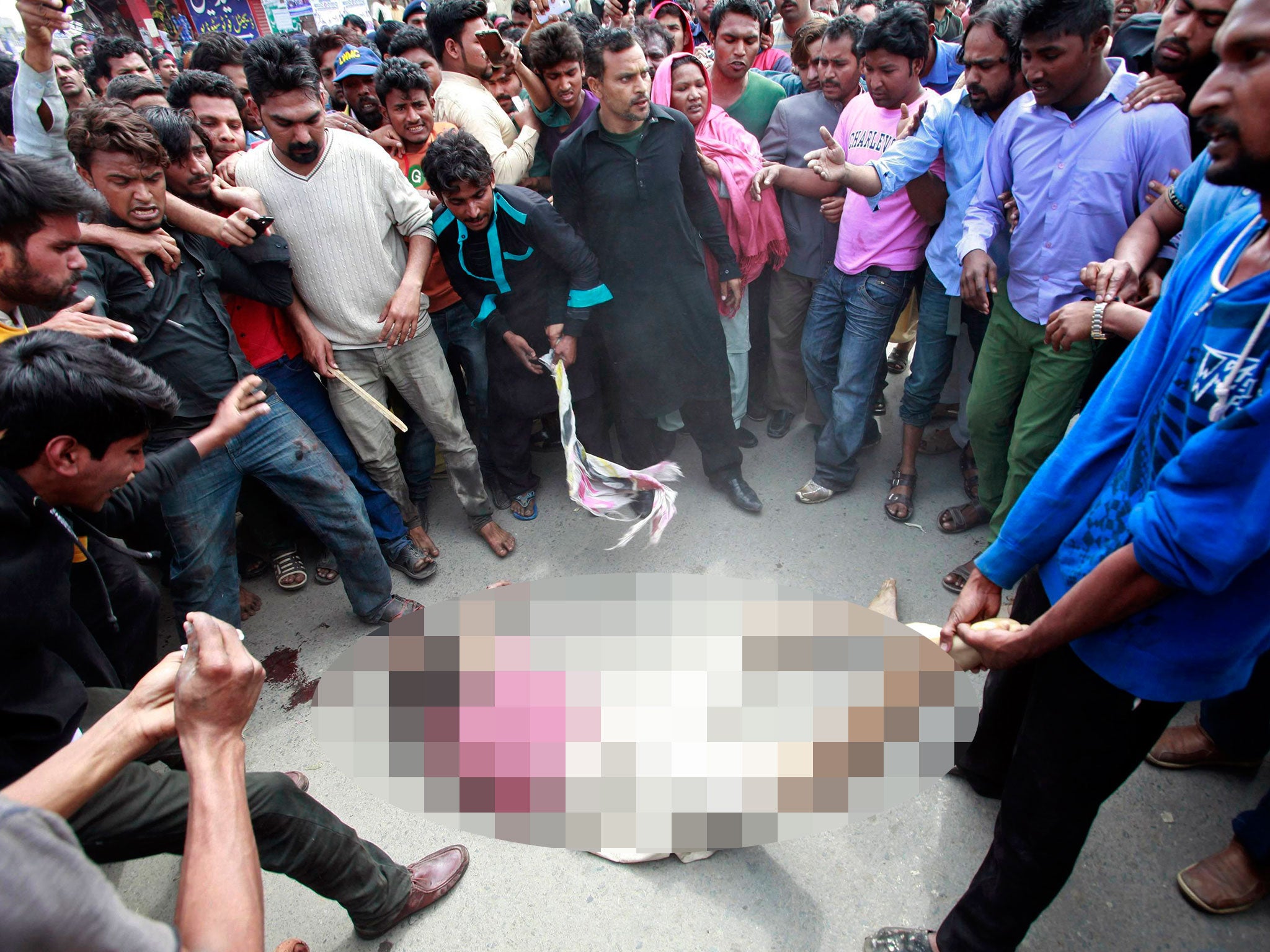 A crowd lynches a man they suspect of being involved in a suicide attack on a church in Lahore