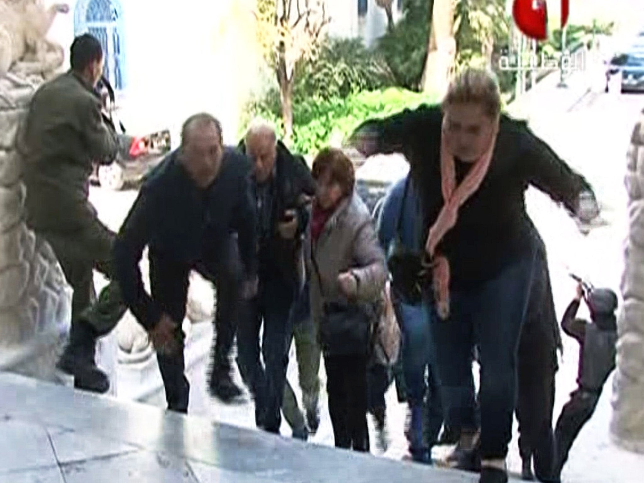 People make their escape from the Bardo Museum in Tunis during the attack in March