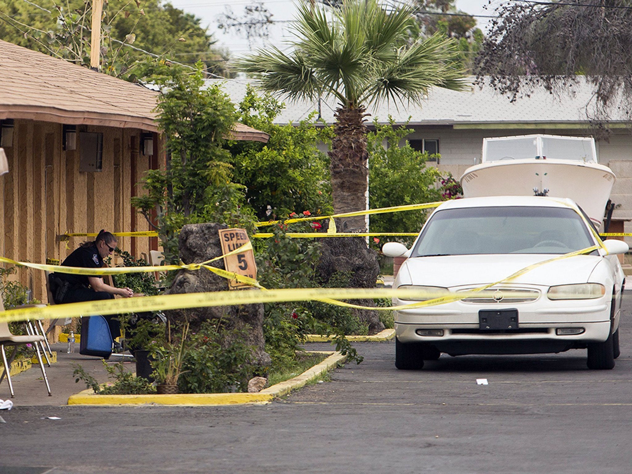 Police tape off the room at the Mesa Tri-City Inn, the scene of the shootings