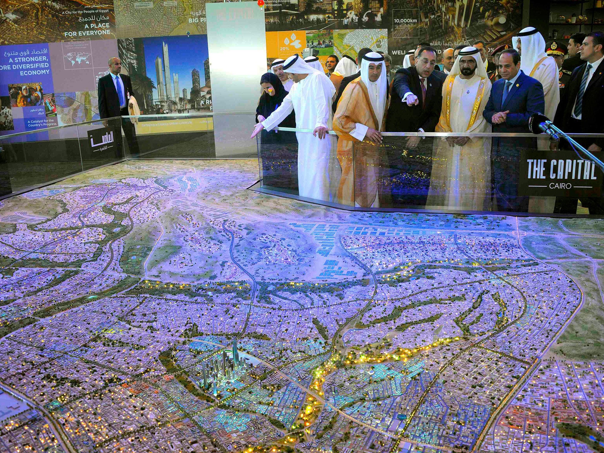 Egyptian President Abdel Fattah al-Sisi (R), United Arab Emirates (UAE) counterpart Sheikh Mohammed bin Rashid al-Maktoum (2nd R), and Egyptian investment minister Ashraf Salman (3rd R) look at a scale model of the new Egyptian capital Cairo