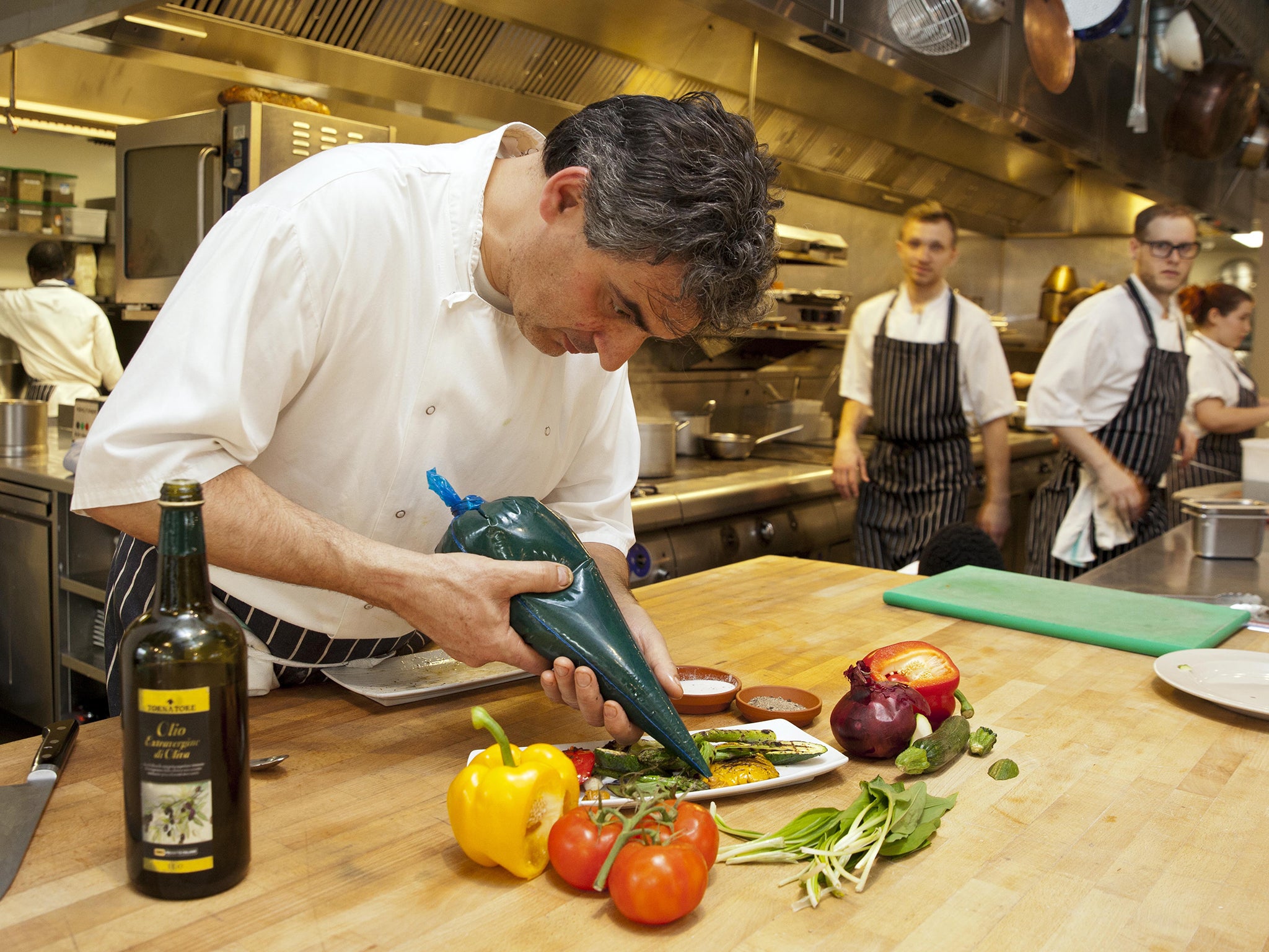 Bruno Loubet puts the finishing touches to a vegetable dish at the Grain Store in King's Cross