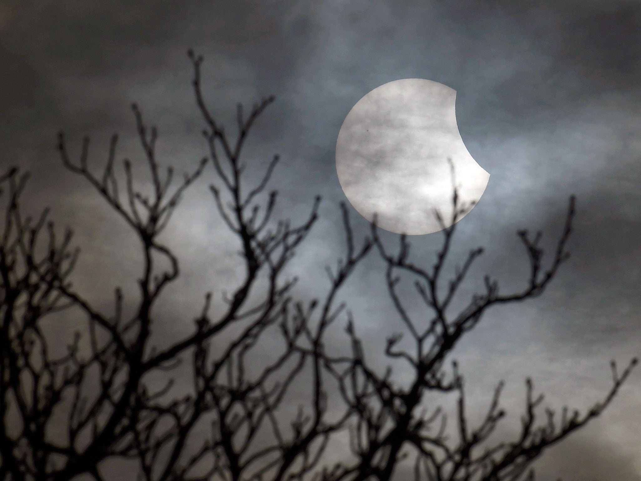 A partial solar eclipse is seen from near Bridgwater, in south western England