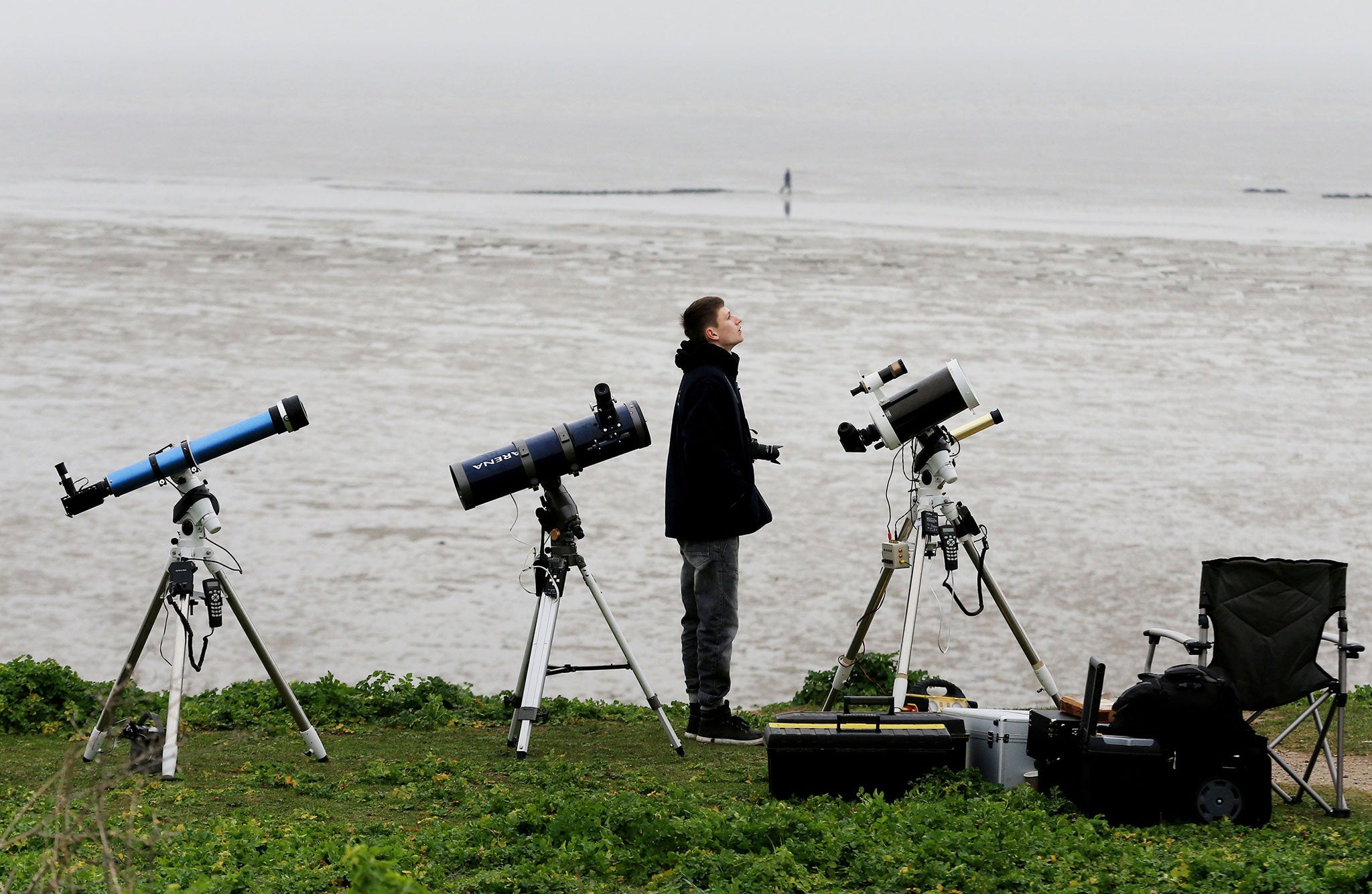 A star-gazer looks disappointedly towards a cloudy sky in Kent for today's partial solar eclipse