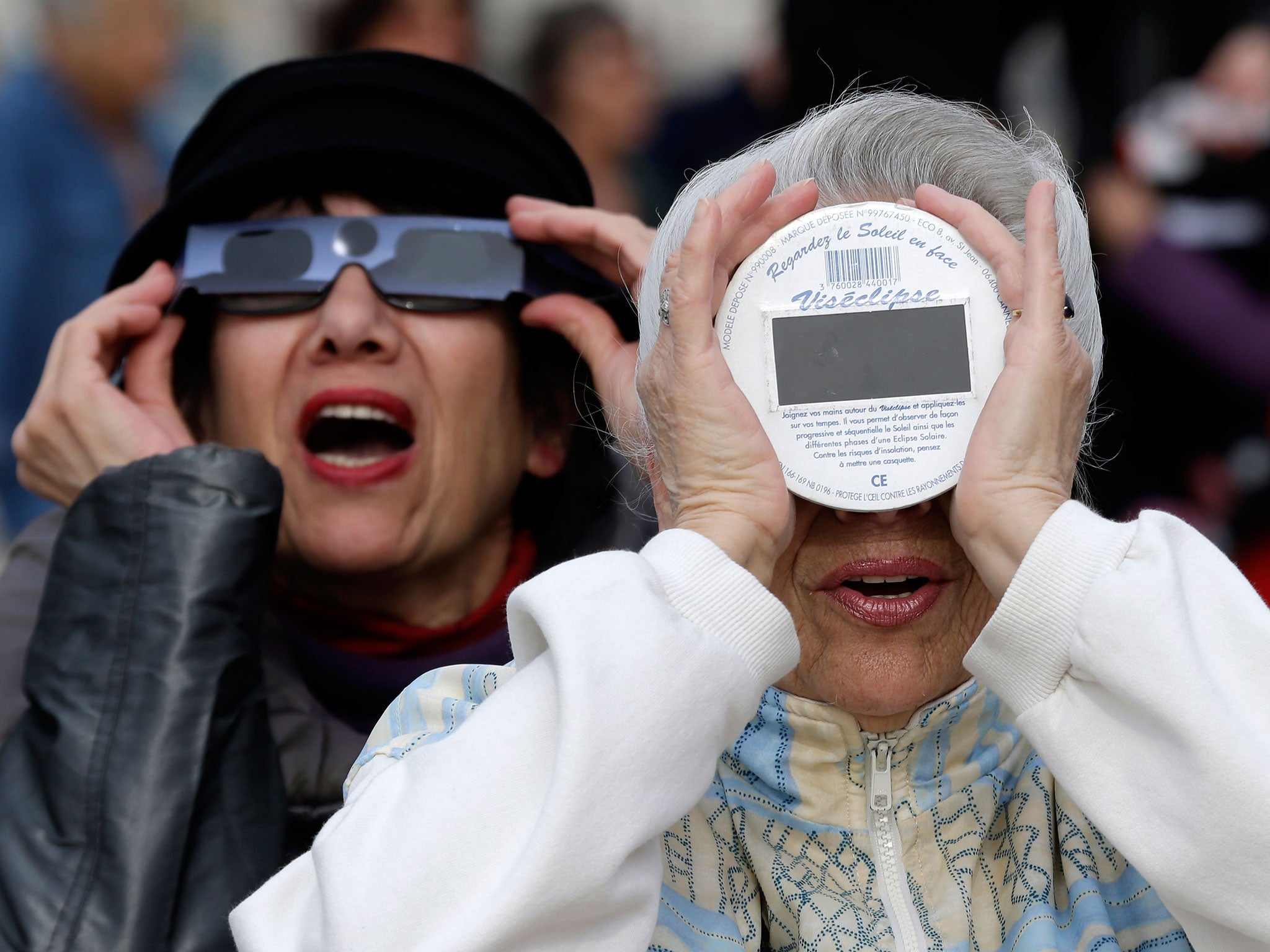 People look at a solar eclipse in the sky of Nice, southeastern France