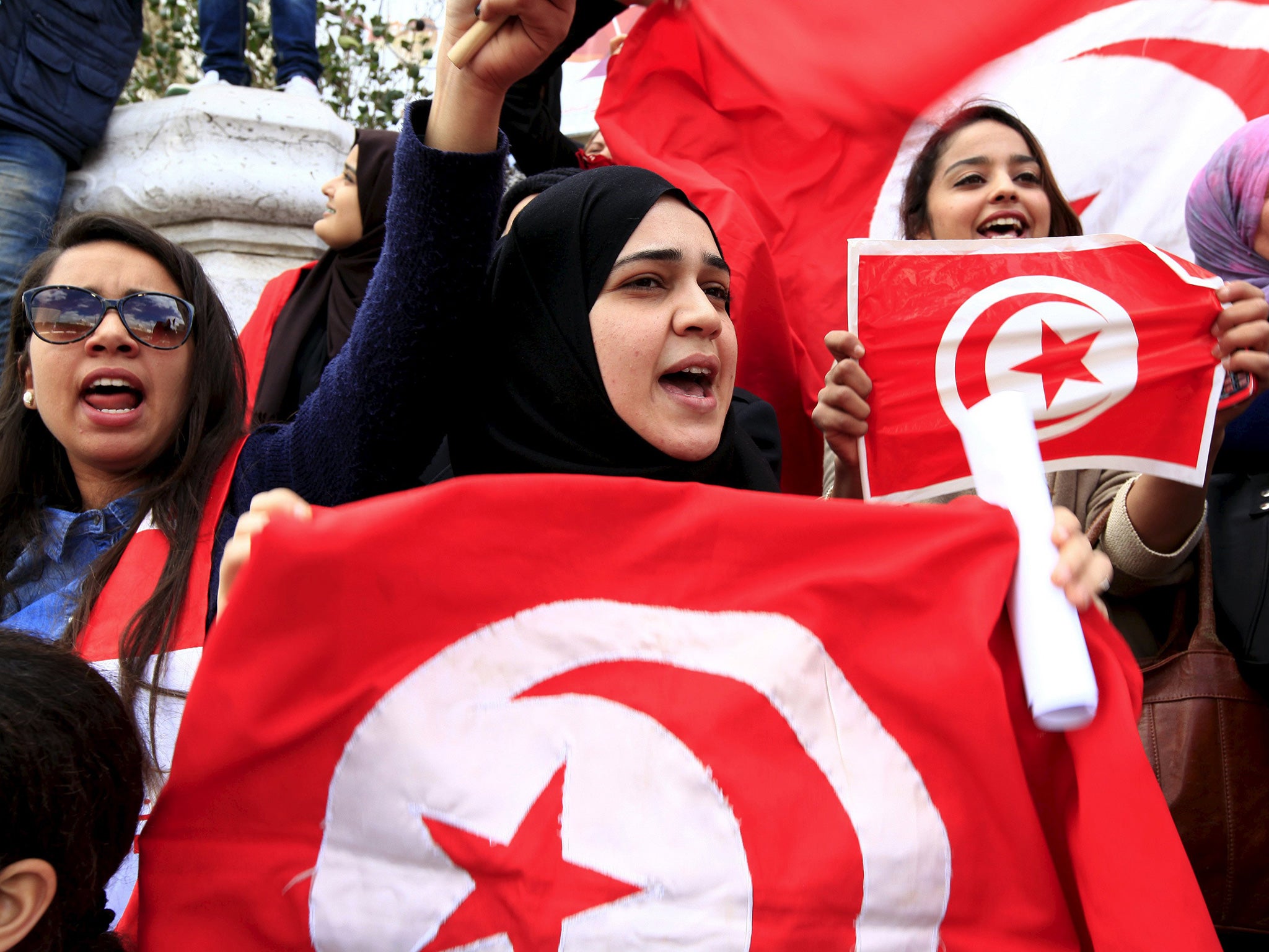 Protesters demonstrate their defiance against the museum killings on the anniversary of independence from France