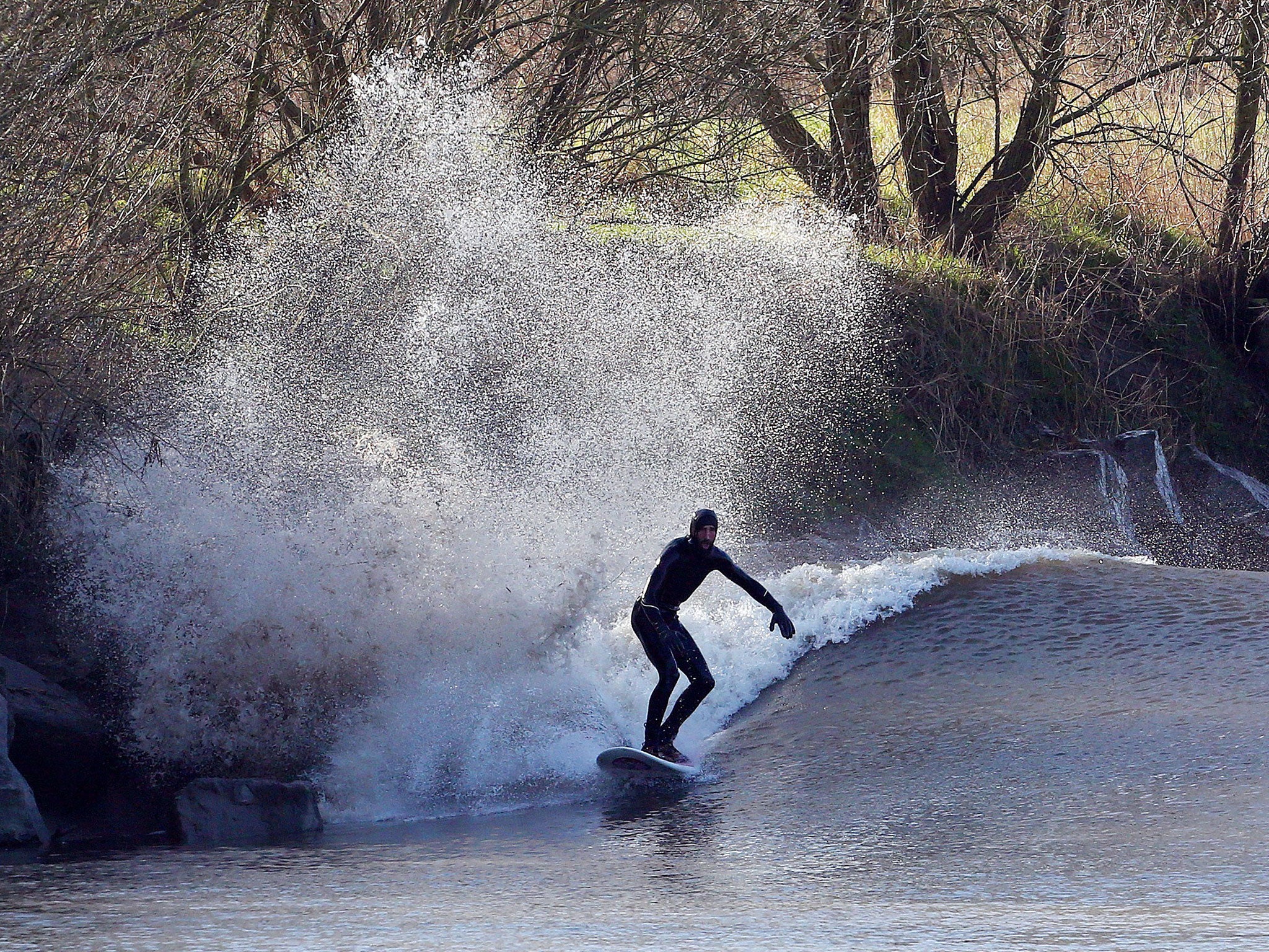 One surfer riding a wave down the Severn on Saturday (AFP/Getty/Geoff Caddick)