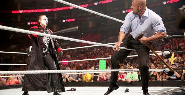 Sting confronts Triple H with his baseball bat