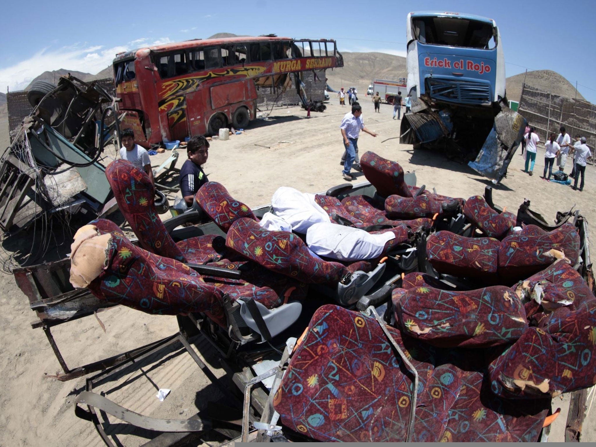 The site of a crash involving three passenger buses and a lorry, near the town of Huarmey, about 300 km north of Lima, on 23 March