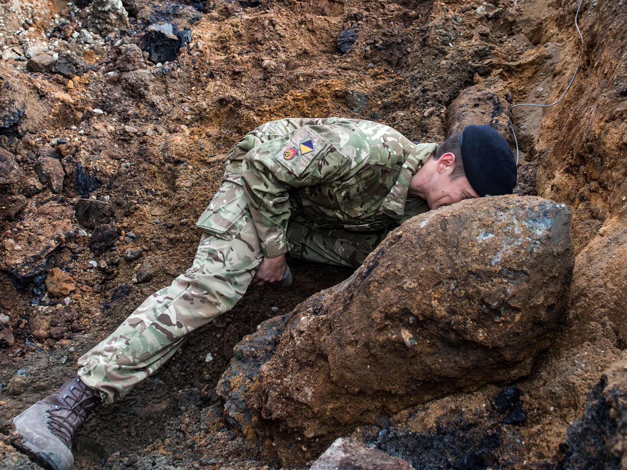 A Royal Logistic Corps Bomb disposal expert checks the fuse on the Second World War bomb found by construction workers in Bermondsey, south-east London.