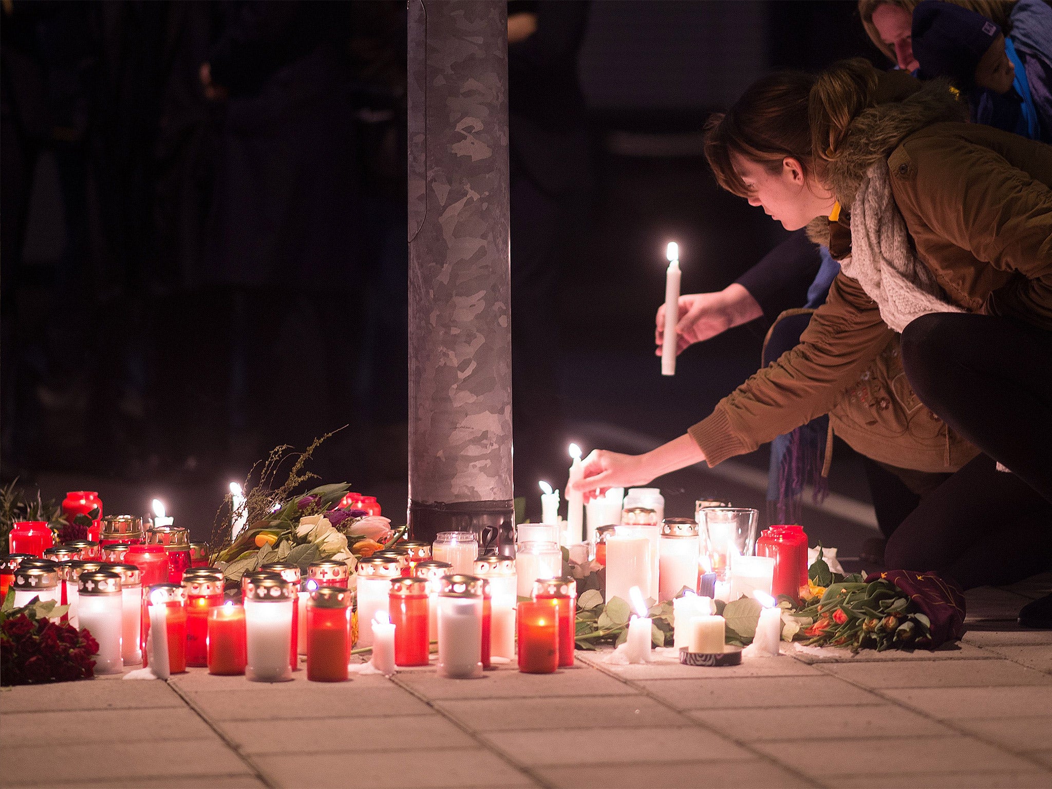 Staff members of Germanwings and Lufthansa hold a candlelight vigil outside the headquarters of Germanwings in Cologne