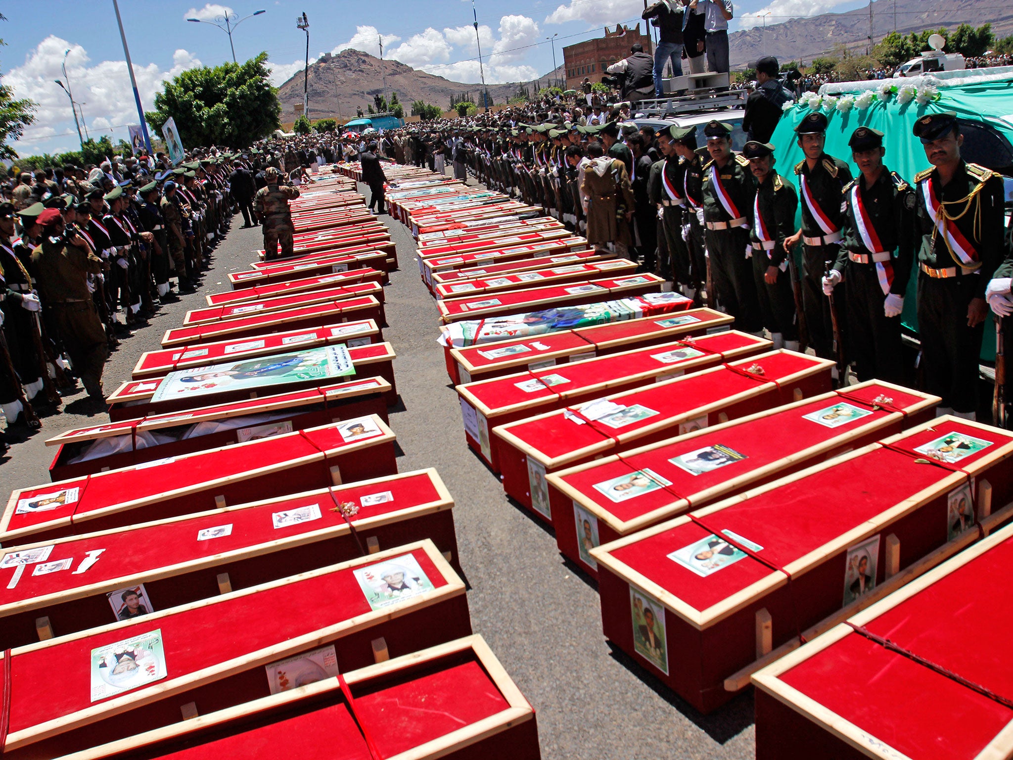 Houthi Shiite mourners attend the funeral procession of victims who were killed from a triple suicide bombing attack on mosques in Sanaa, Yemen