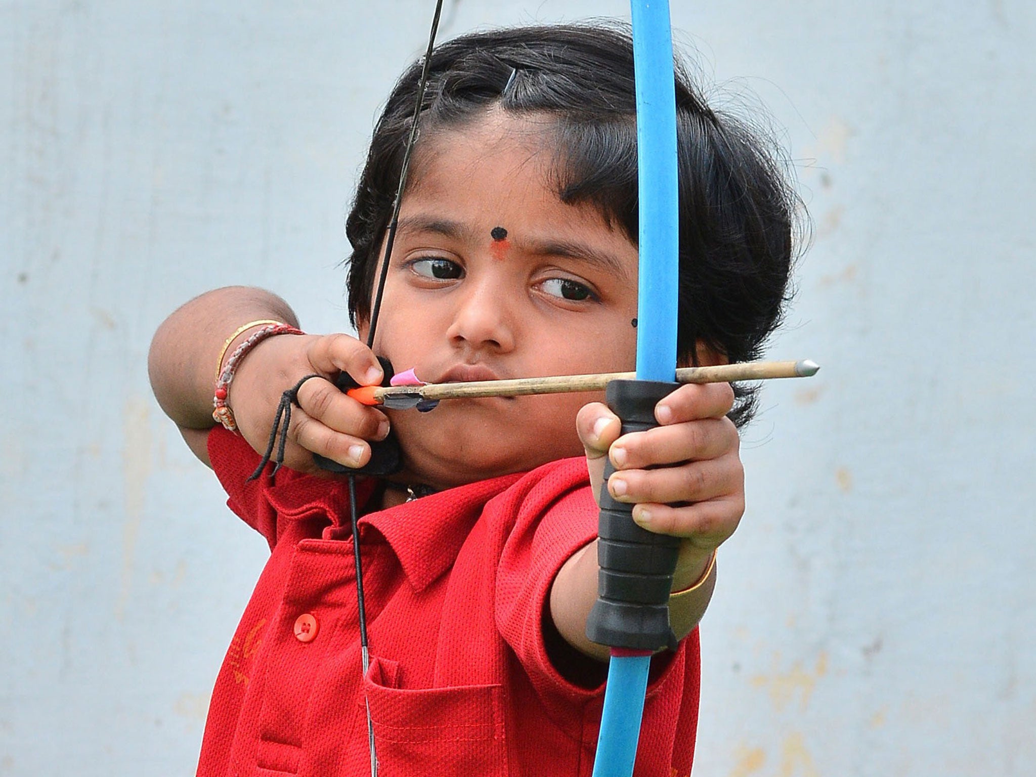 Two-year-old Indian archer Dolly Shivani Cherukuri takes aim during a world record target