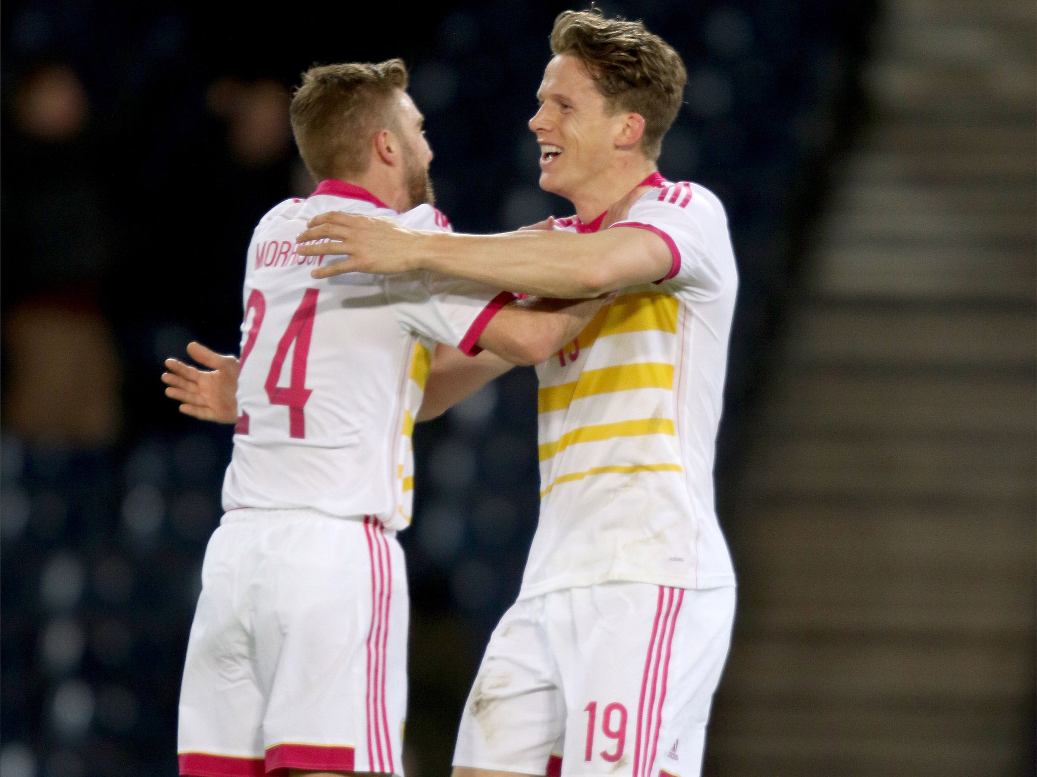 Christophe Berra (right) celebrates his late winner for Scotland with James Morrison