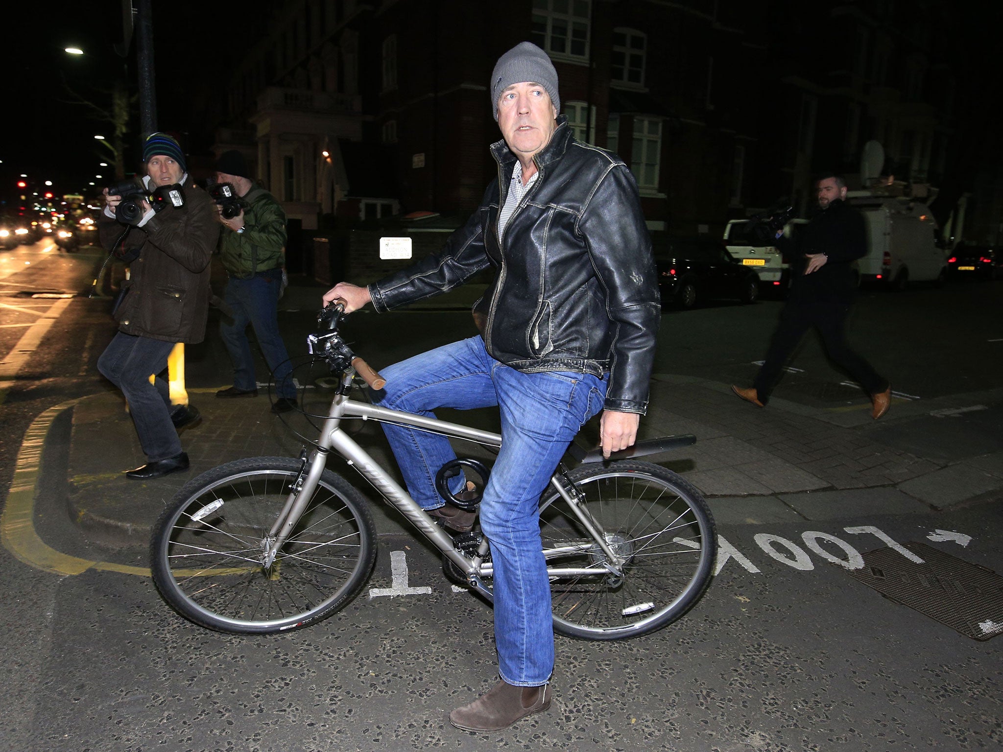 Jeremy Clarkson leaves his home by bicycle following the announcement by the BBC that it would not be renewing his contract