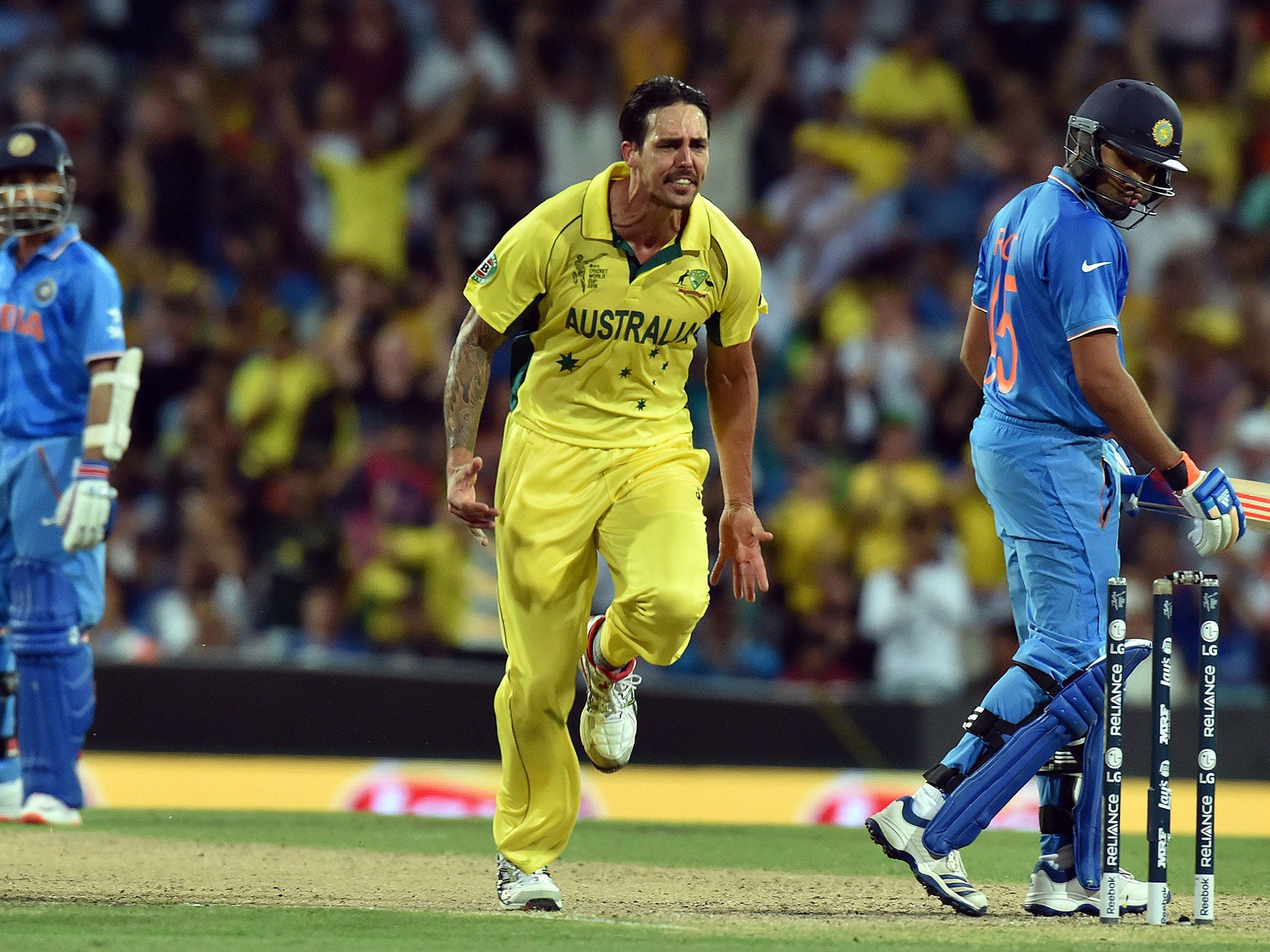 Mitchell Johnson celebrates clean-bowling Rohit Sharma