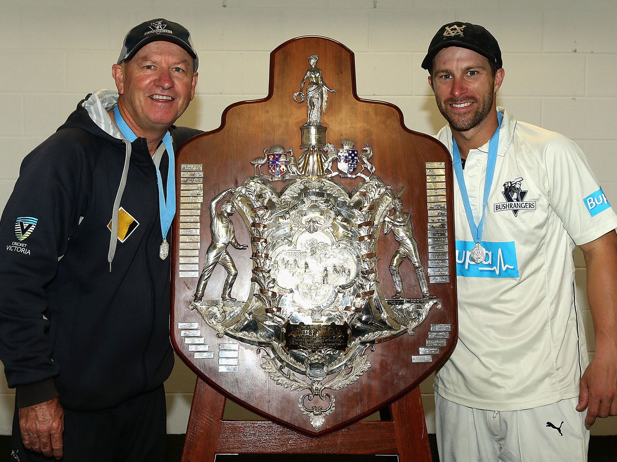 Wade (right) and coach Greg Shipperd celebrate Victoria's Sheffield Shield final success