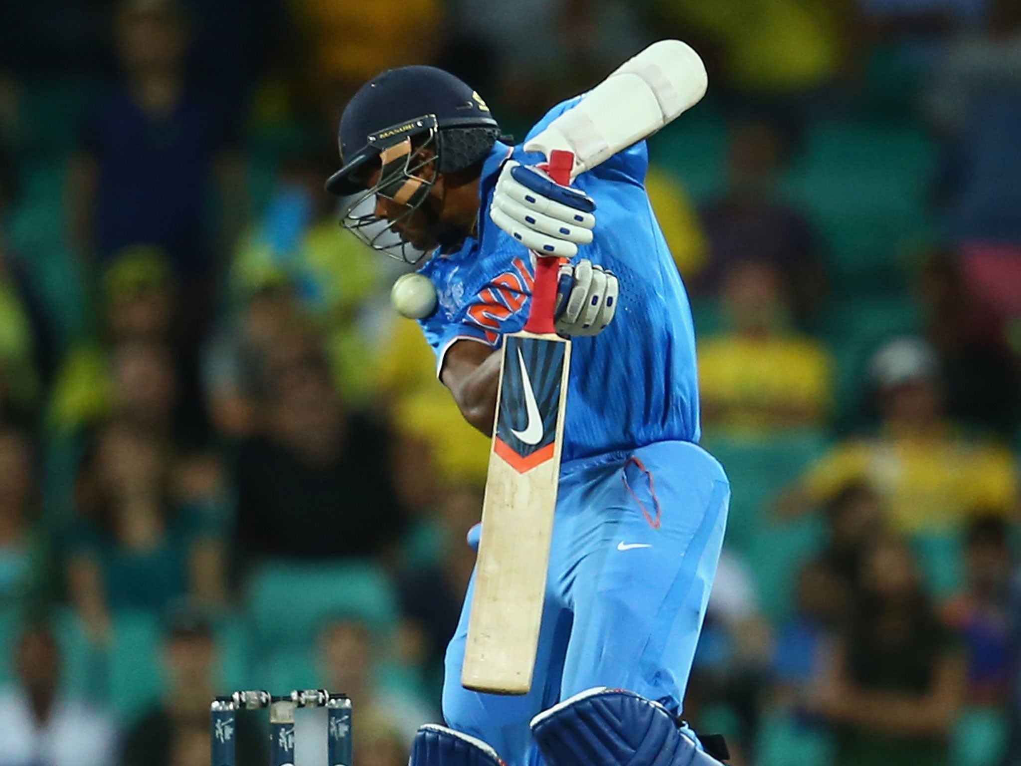 Umesh Yadav is hit in the head by a Mitchell Starc bouncer