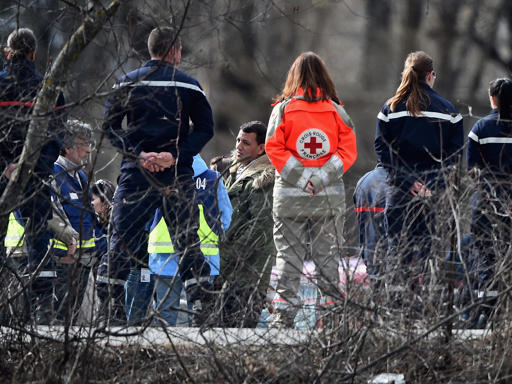 Victims’ relatives join carers outside the school gym in Seyne